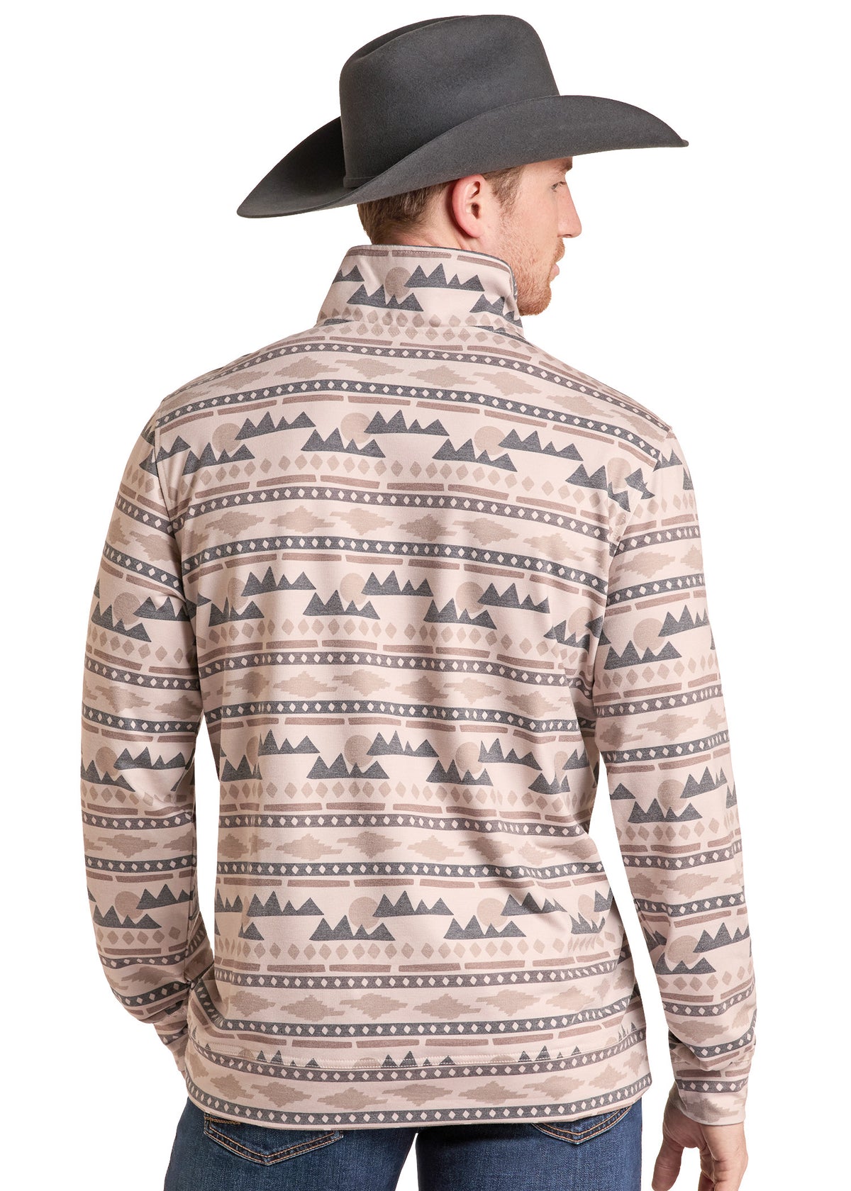 A man wearing a beige long-sleeve quarter-zip shirt with a dark gray geometric mountain pattern, shown from the back. He is also wearing a dark gray cowboy hat and blue jeans, photographed against a solid white background.