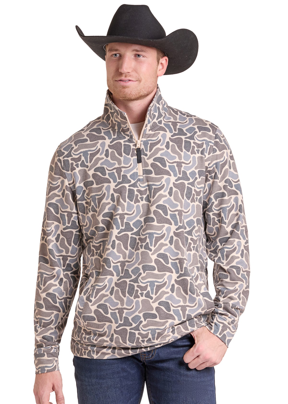 A man wearing a black cowboy hat and a long-sleeve quarter-zip pullover with a brown, gray, and beige stone-pattern print, paired with blue jeans, against a plain white background.
