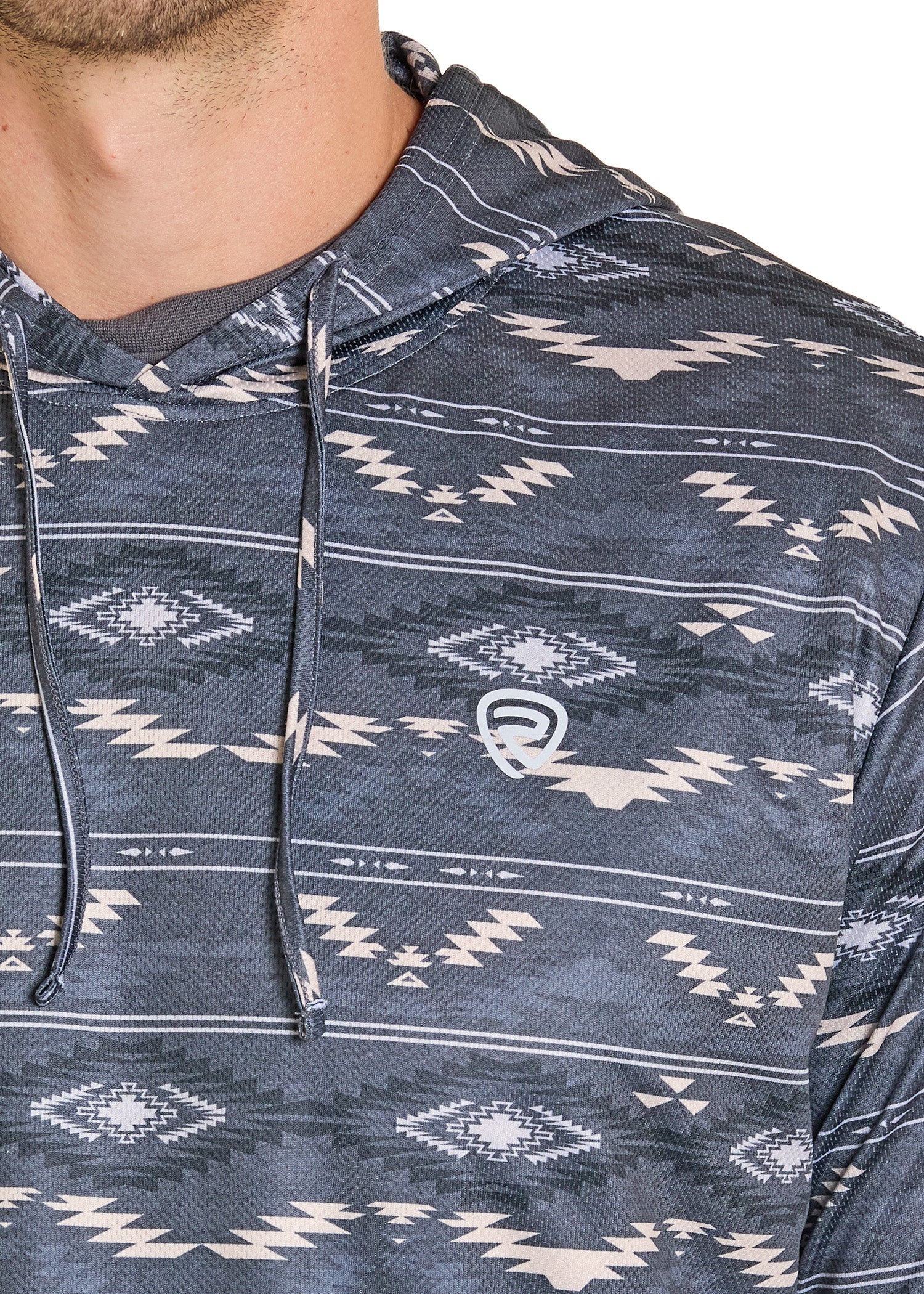 Close-up of a person wearing a navy blue hoodie with white geometric patterns on a white background