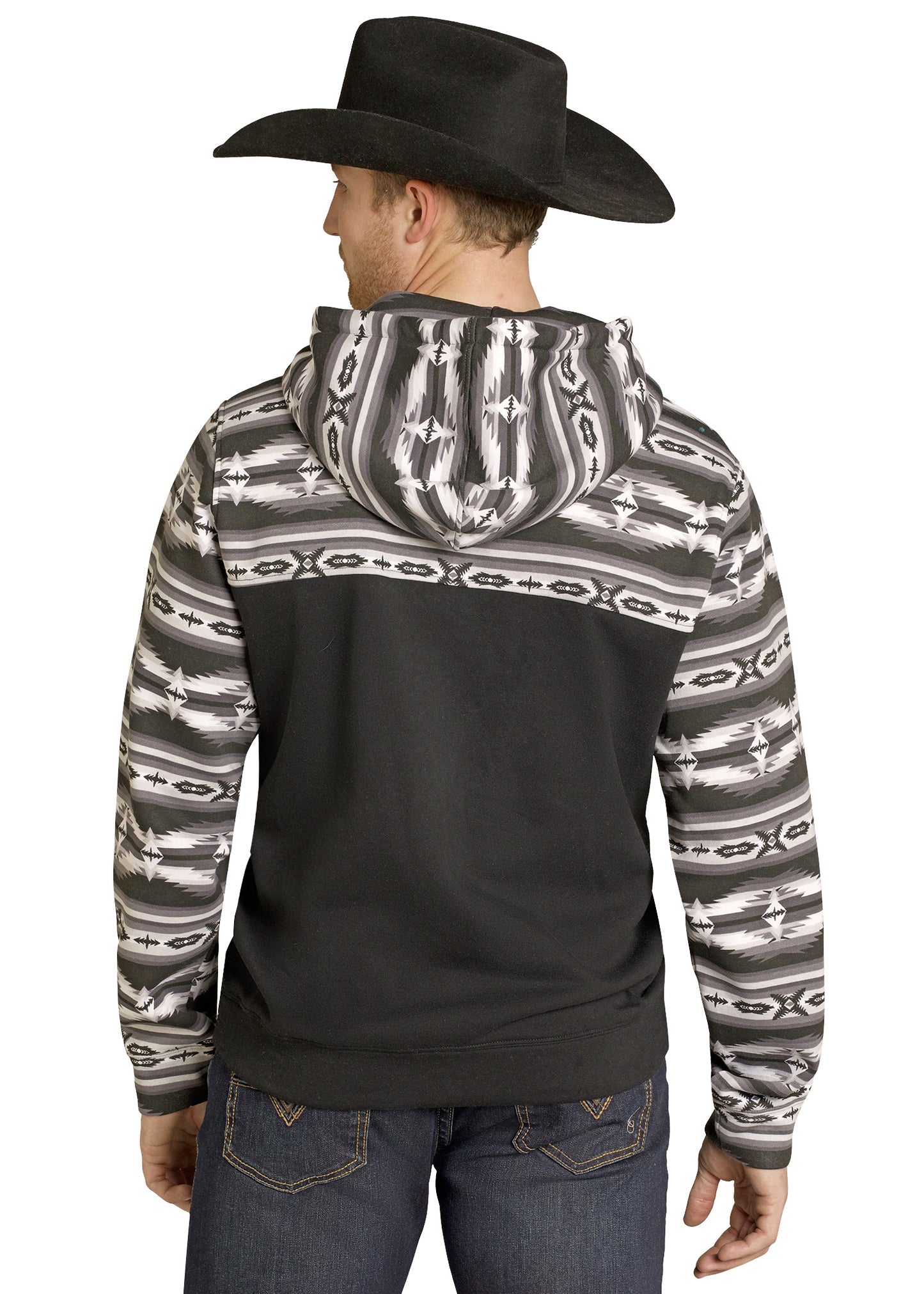A man in a black cowboy hat, Rock & Roll Denim Aztec Block Hoodie with Southwestern design, and blue jeans is pictured from the back against a white background.
