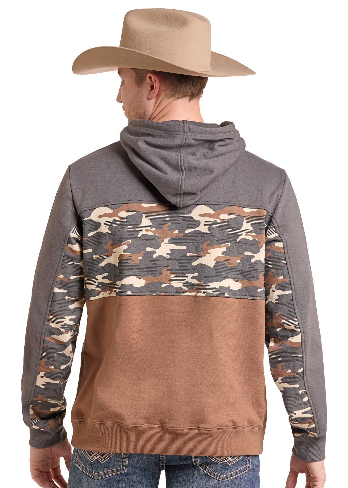 A man wearing a brown and gray color-block hoodie with a camouflage pattern across the upper back and sleeves, shown from the back. He is also wearing a tan cowboy hat and blue jeans against a plain white background.