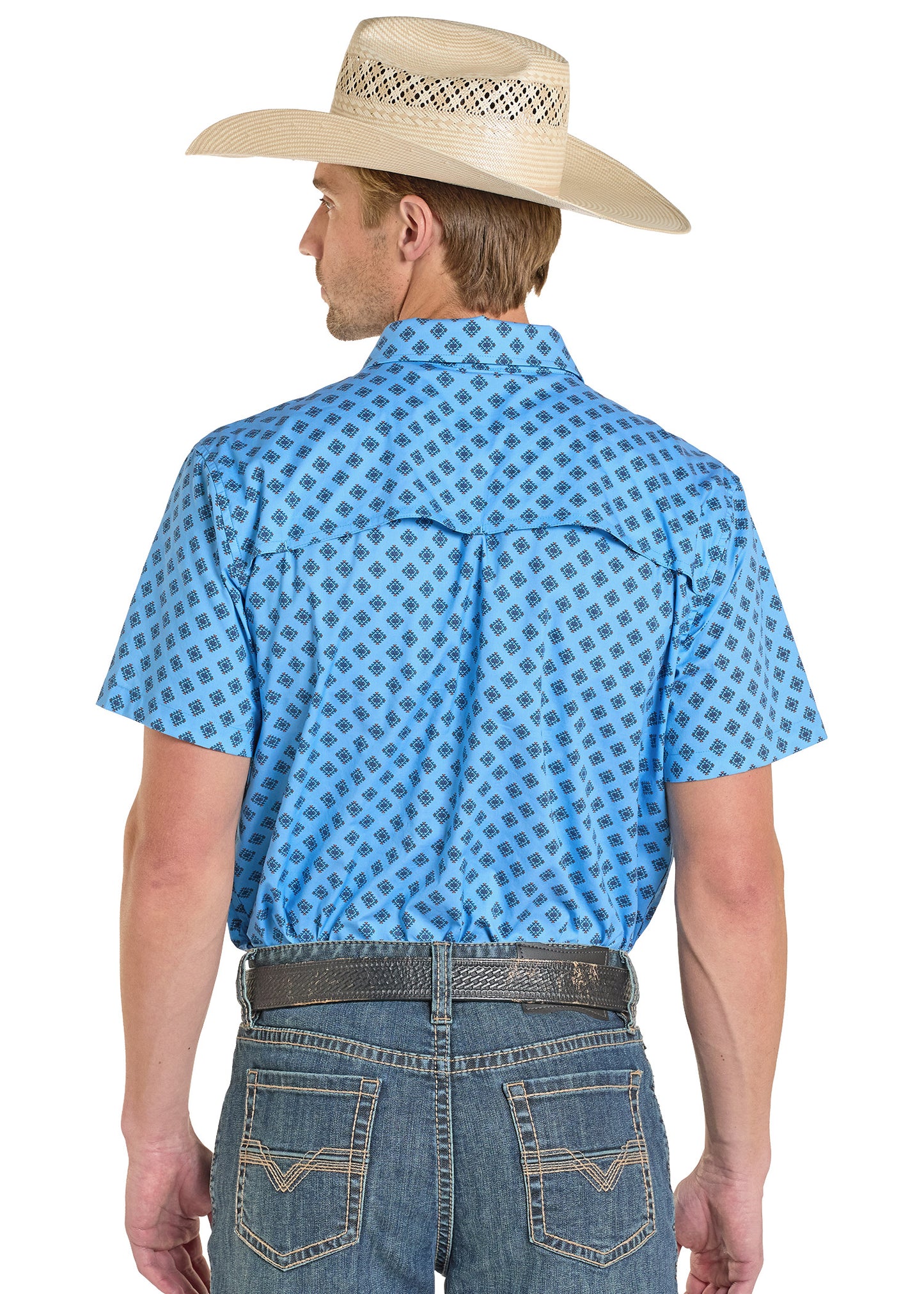 Man wearing a blue Aztec patterned shirt and cowboy hat on a white background