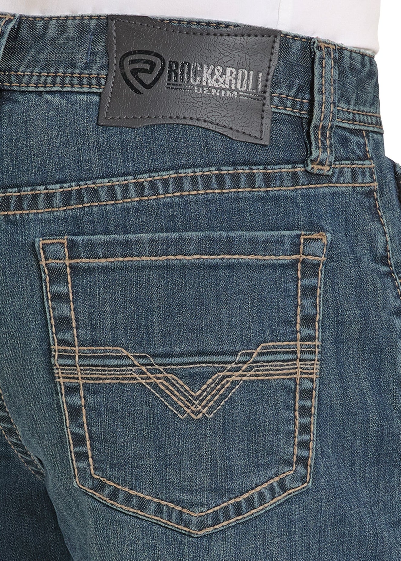 Close-up of blue jeans with a brand label on the back pocket.