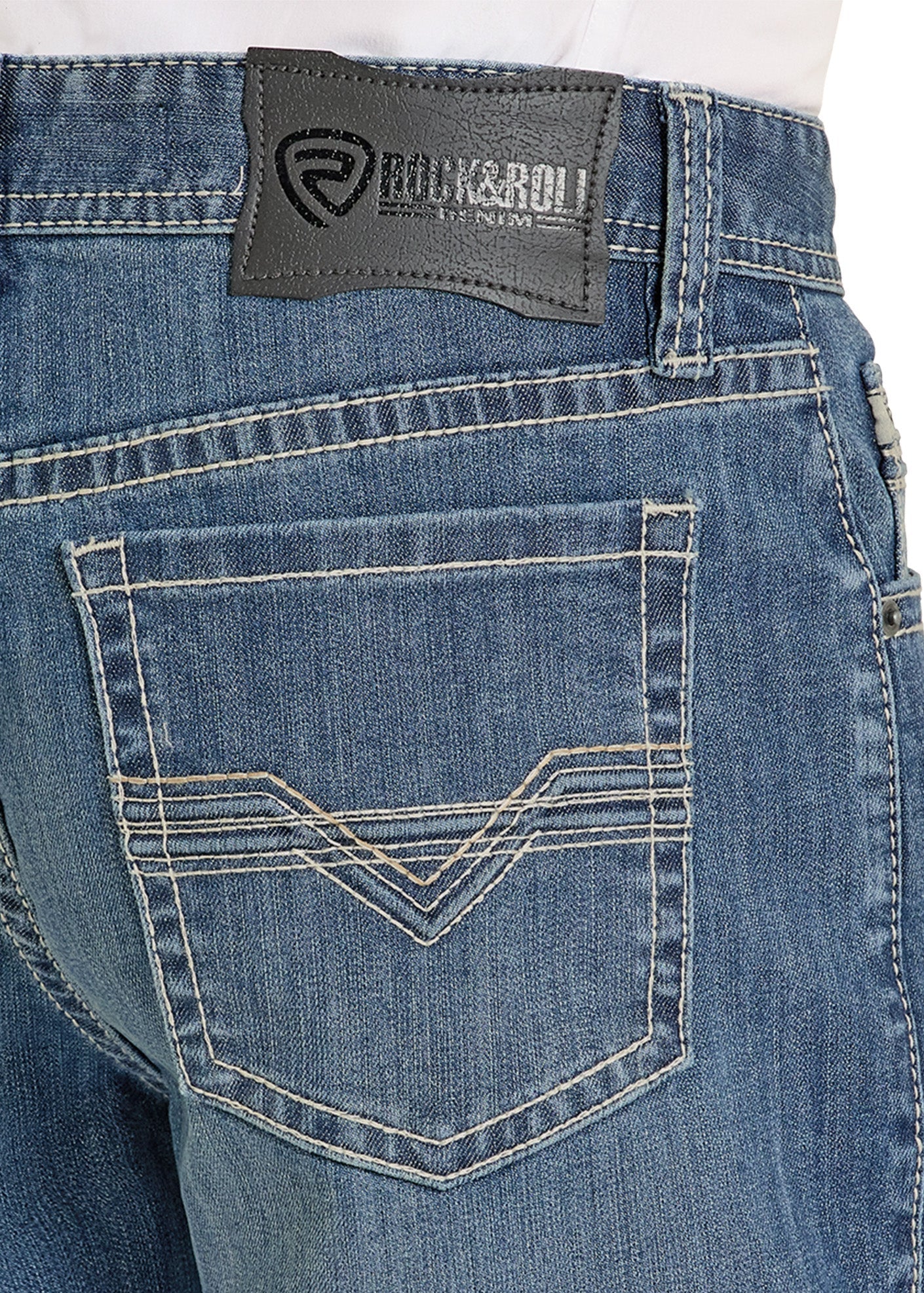 Close-up of blue jeans with a brand label on the back pocket.