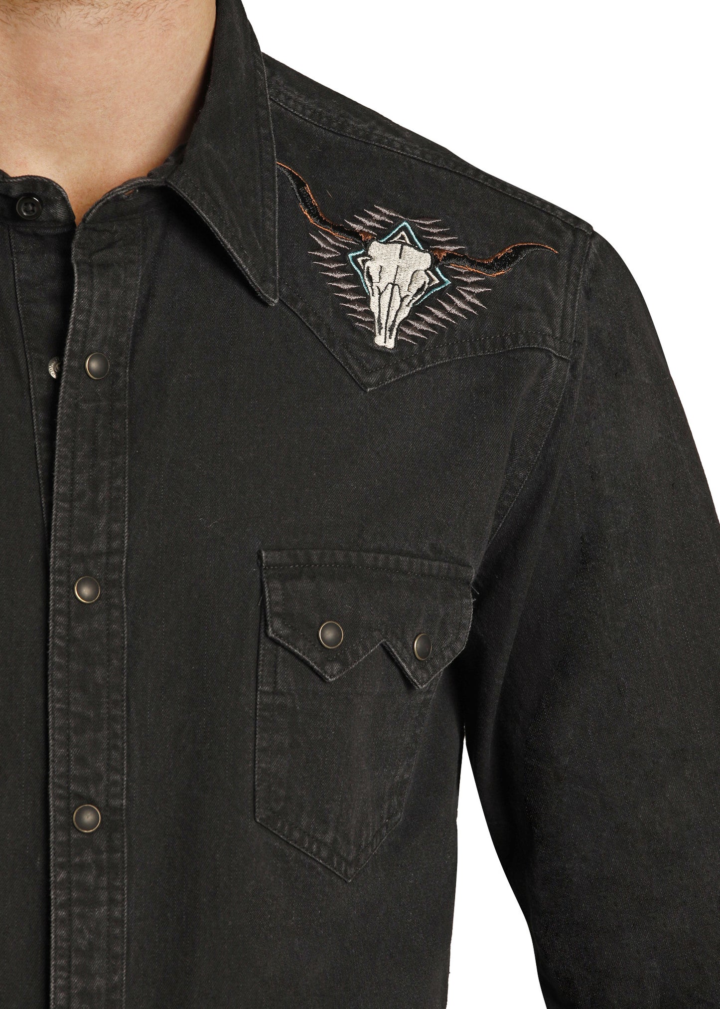 Black denim shirt with a decorative patch on the chest against a white background