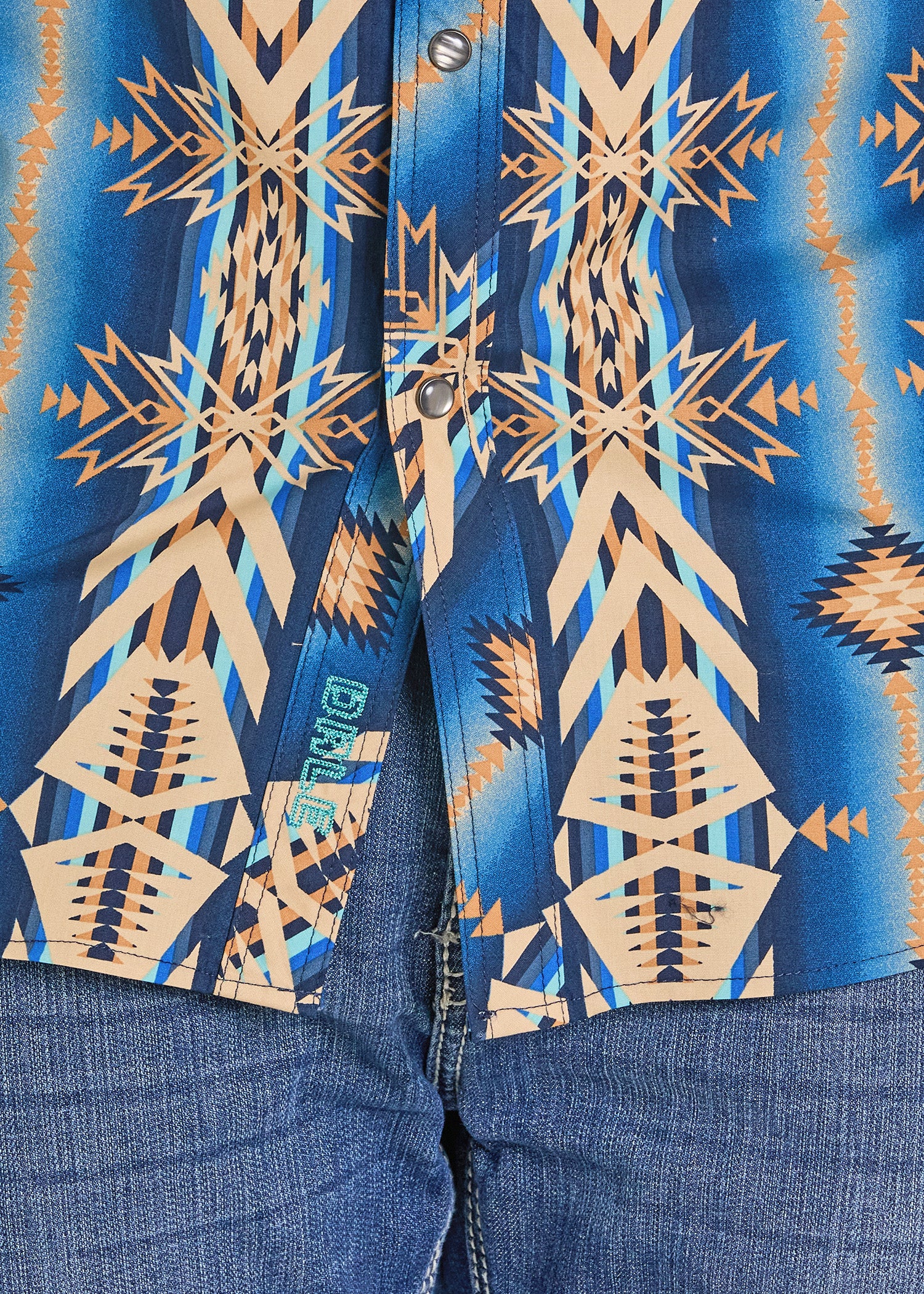 Close-up of a blue shirt with geometric pattern