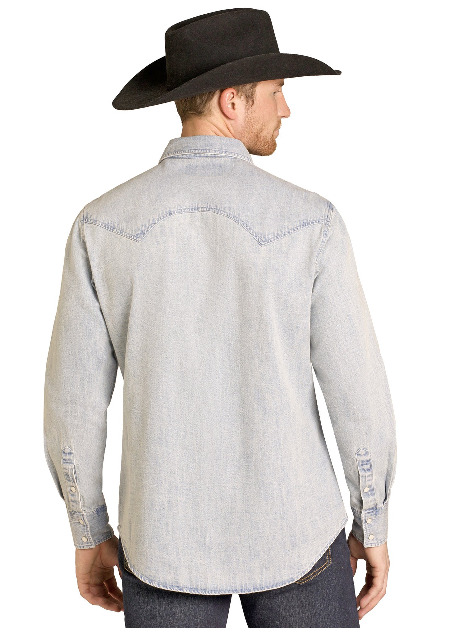 Man wearing a light gray denim shirt and black cowboy hat on a white background