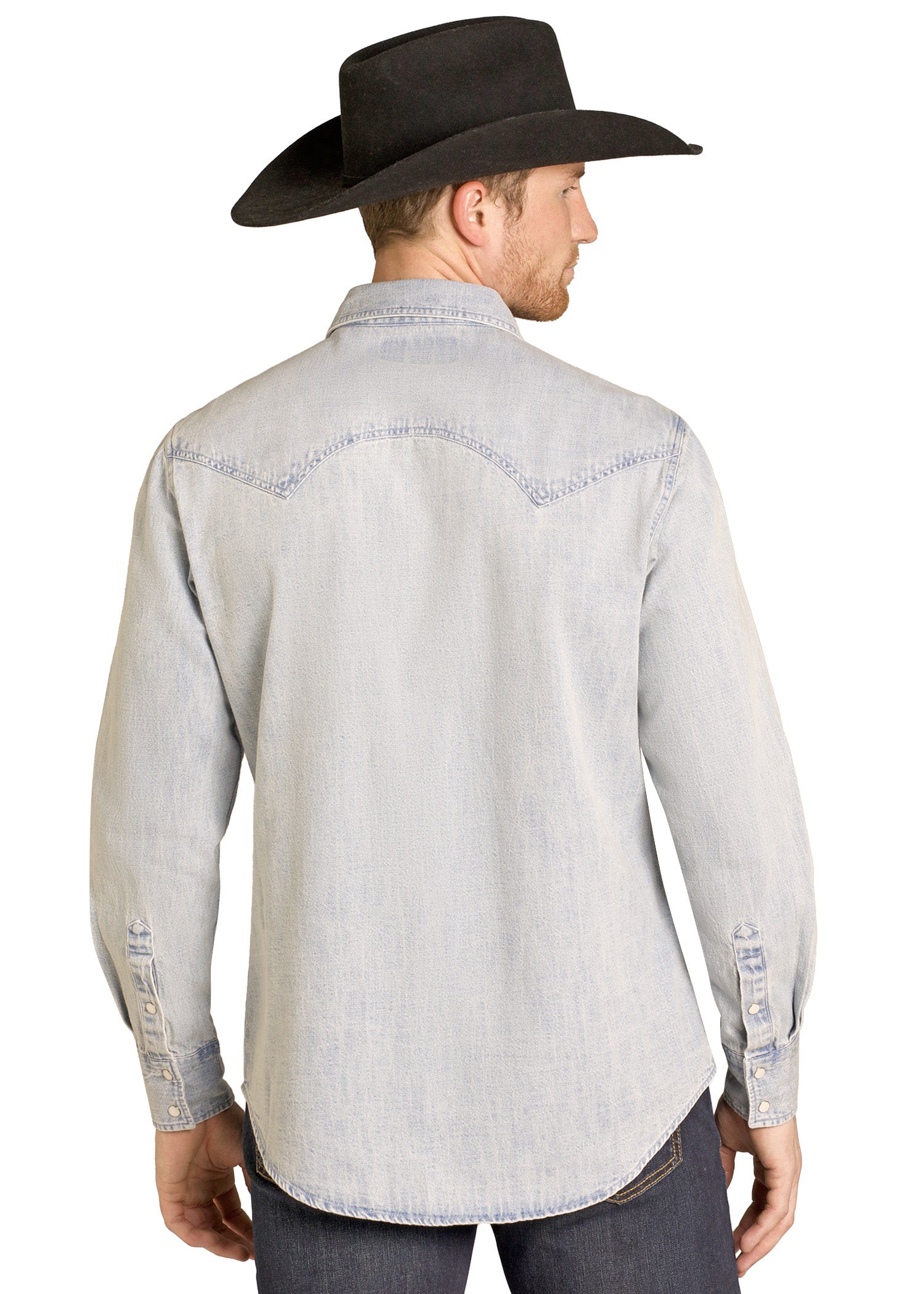 Man wearing a light gray denim shirt and black cowboy hat on a white background