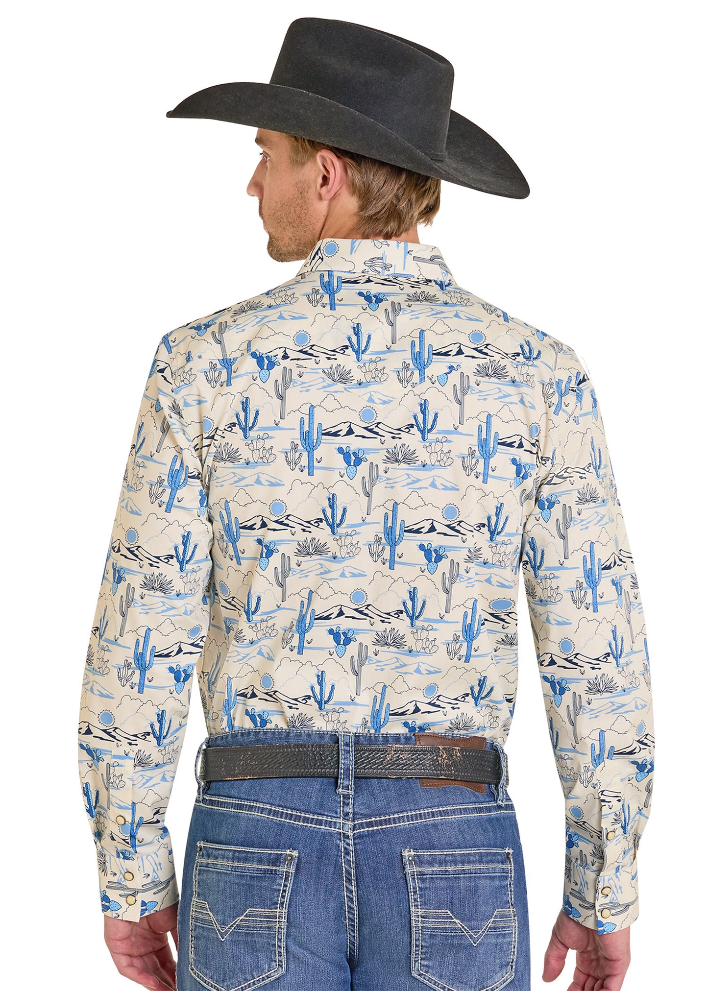 Man wearing a patterned shirt with cactus design, blue jeans, and a black cowboy hat on a white background