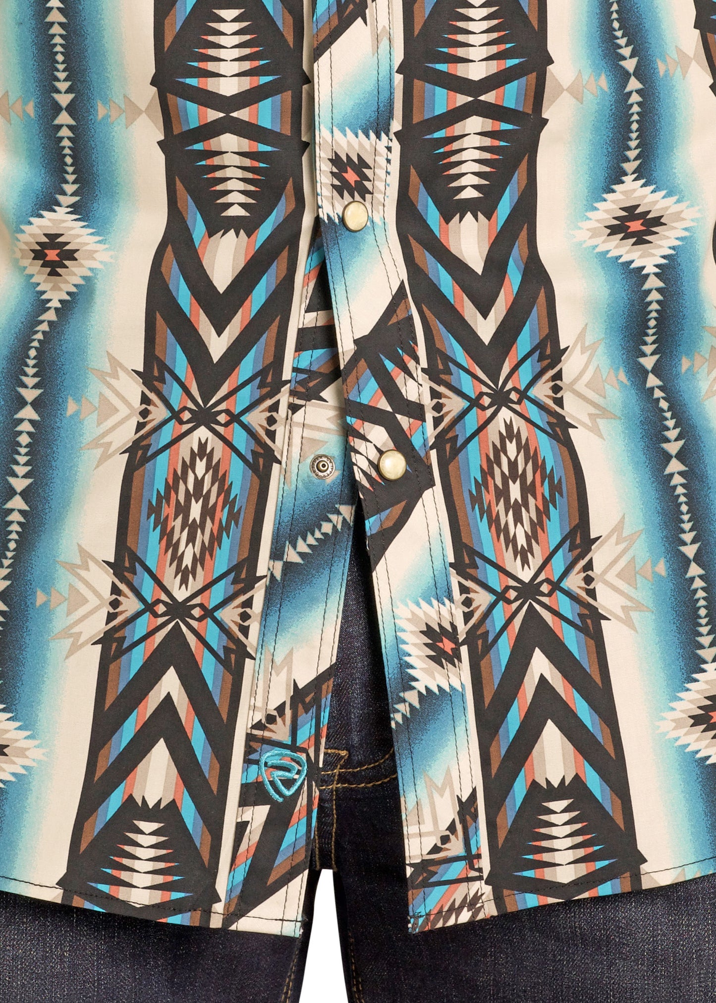 Close-up of a patterned shirt with geometric design in blue, brown, and beige.