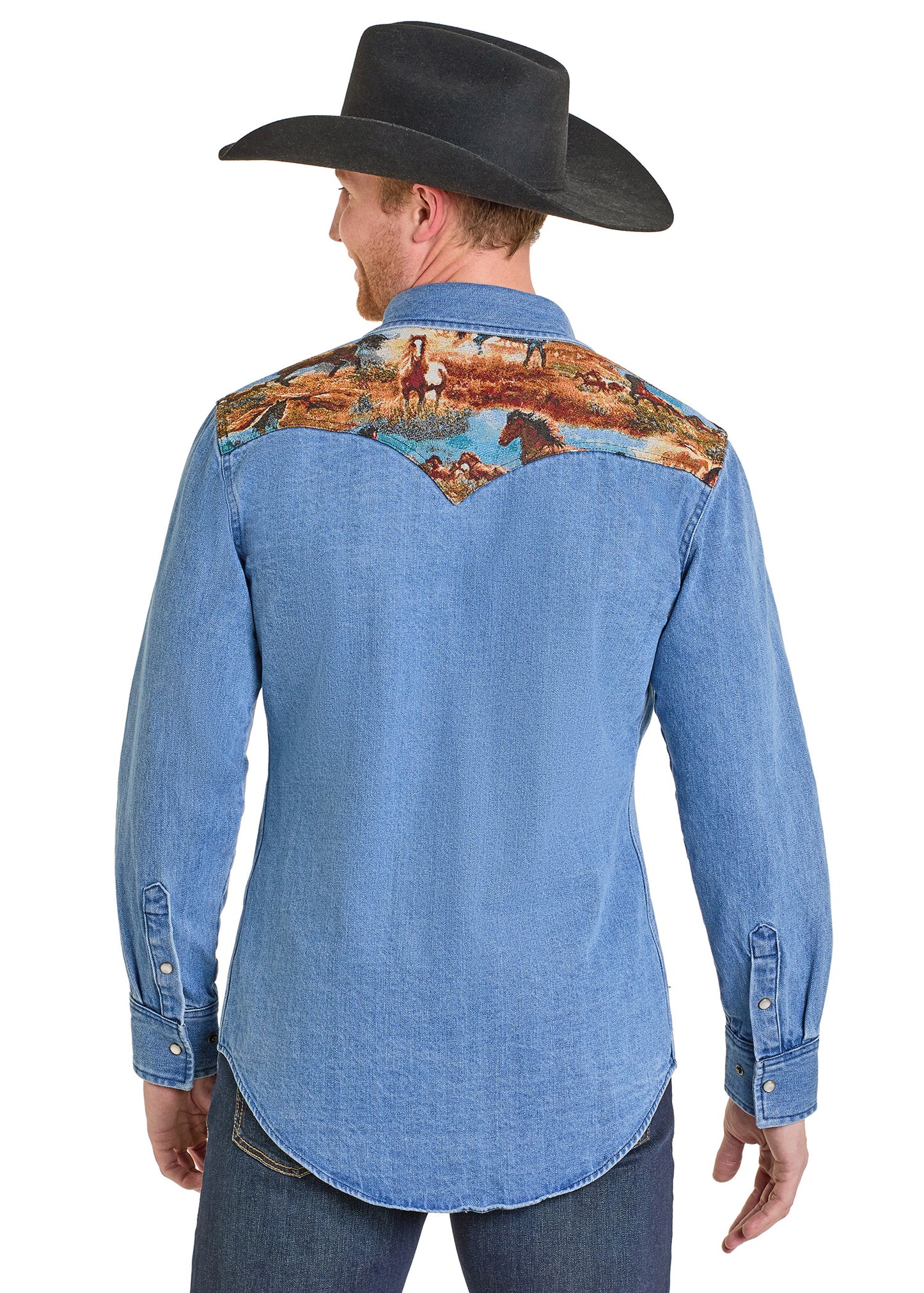 Man wearing a blue denim shirt with a colorful embroidered back design on a white background