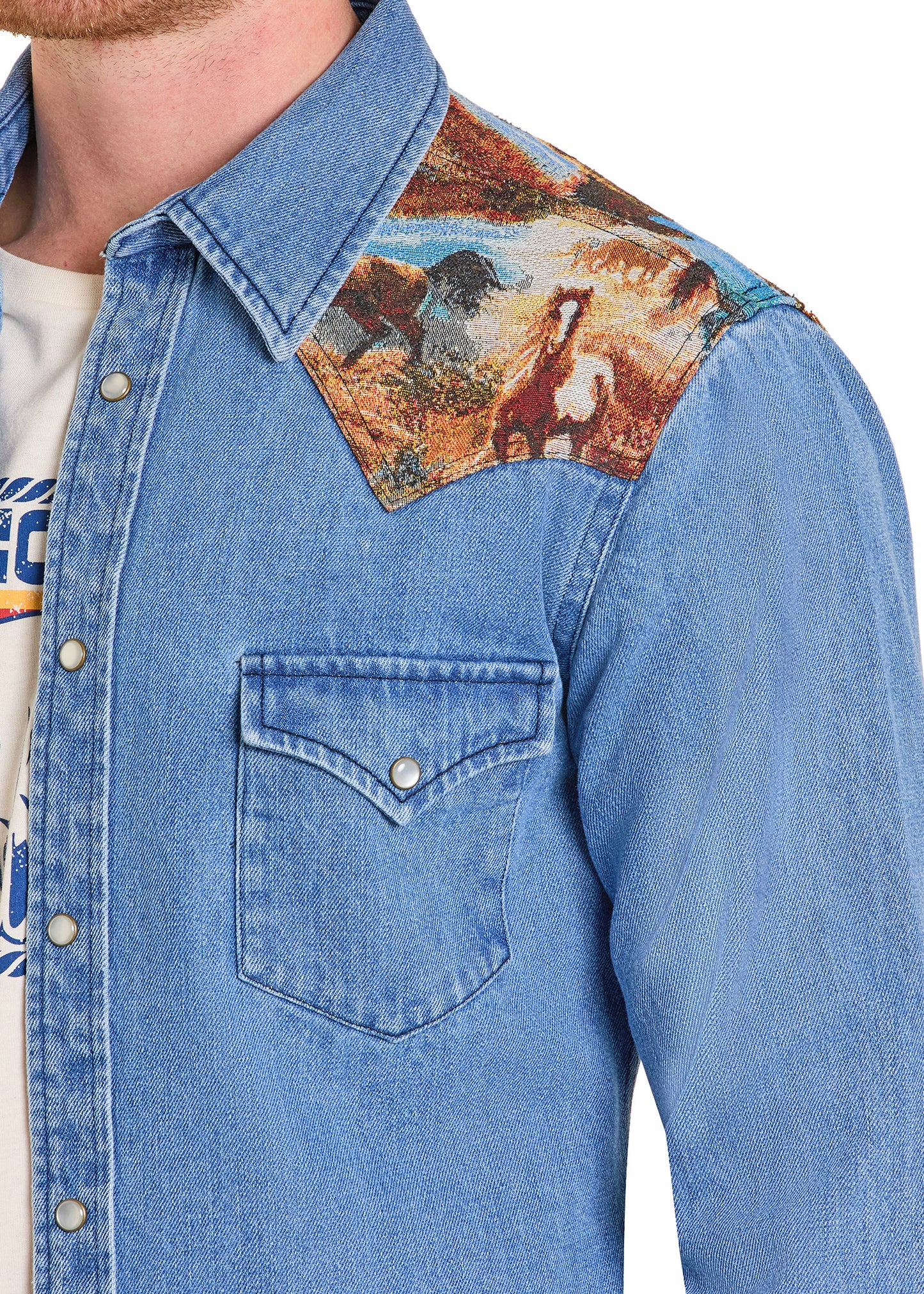 Blue denim shirt with a patch of a horse on the shoulder against a white background