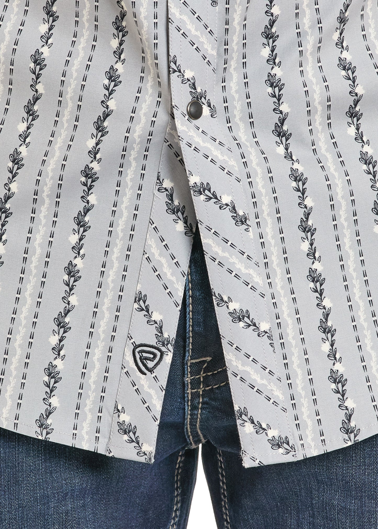 Close-up of a patterned jacket with floral designs on a plain background