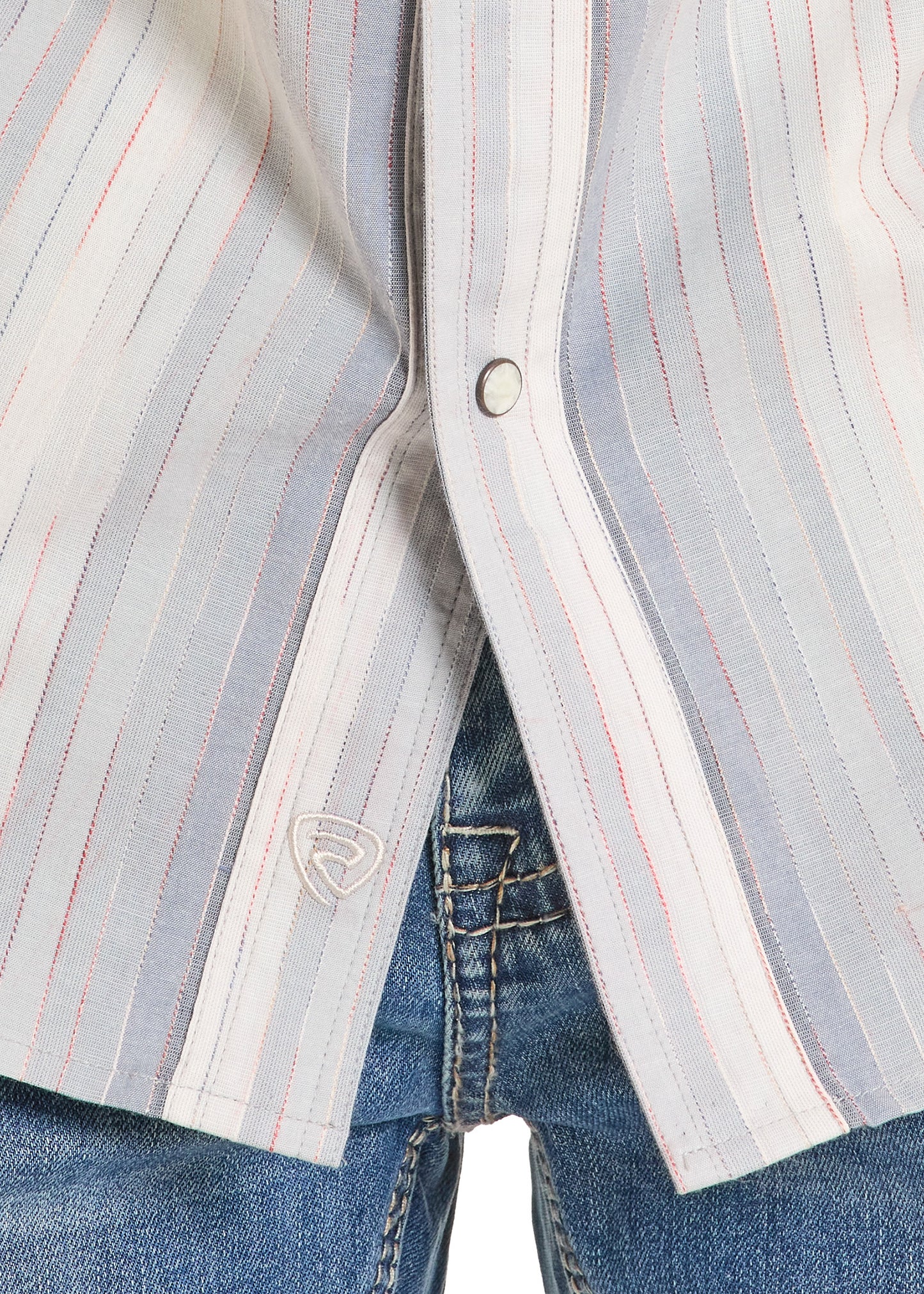 Close-up of a striped shirt with a button and jeans in the background