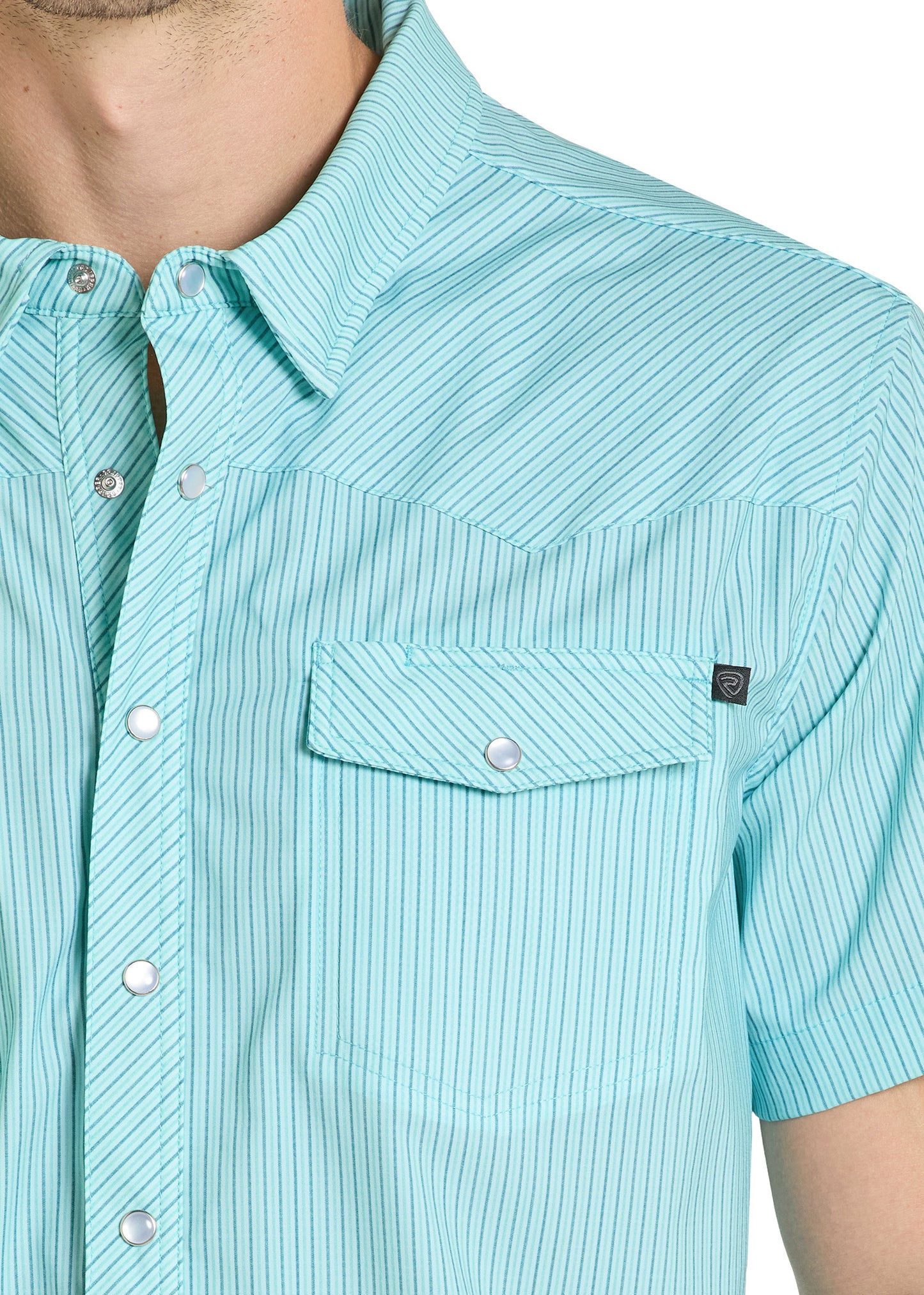 Close-up of a light blue button-up shirt with a pocket and brand logo.