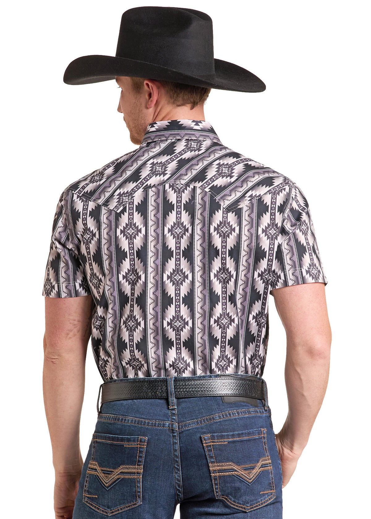 The back of a man wearing a short sleeve sleeve black Aztec shirt