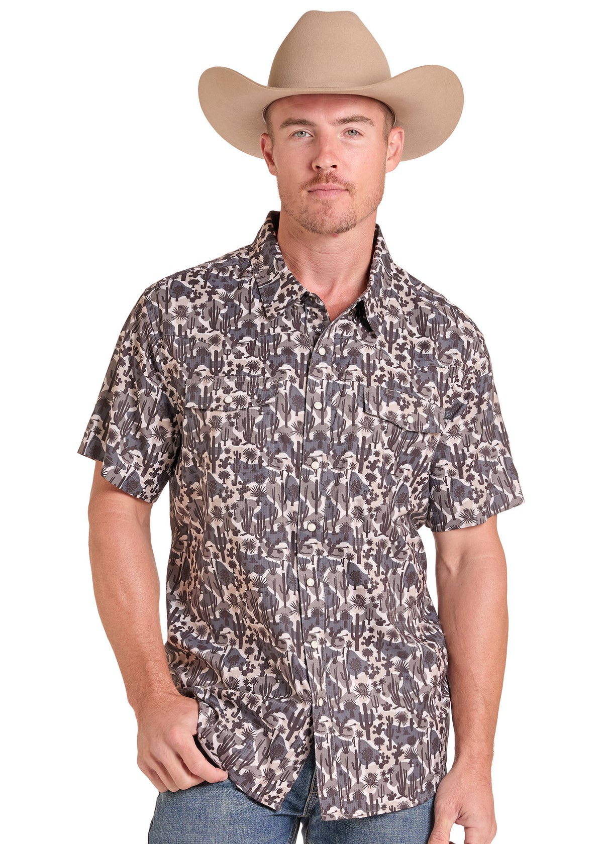 A man wearing a tan cowboy hat and a short-sleeve button-down shirt with a dark gray and beige animal print pattern, paired with blue jeans, photographed against a plain white background.