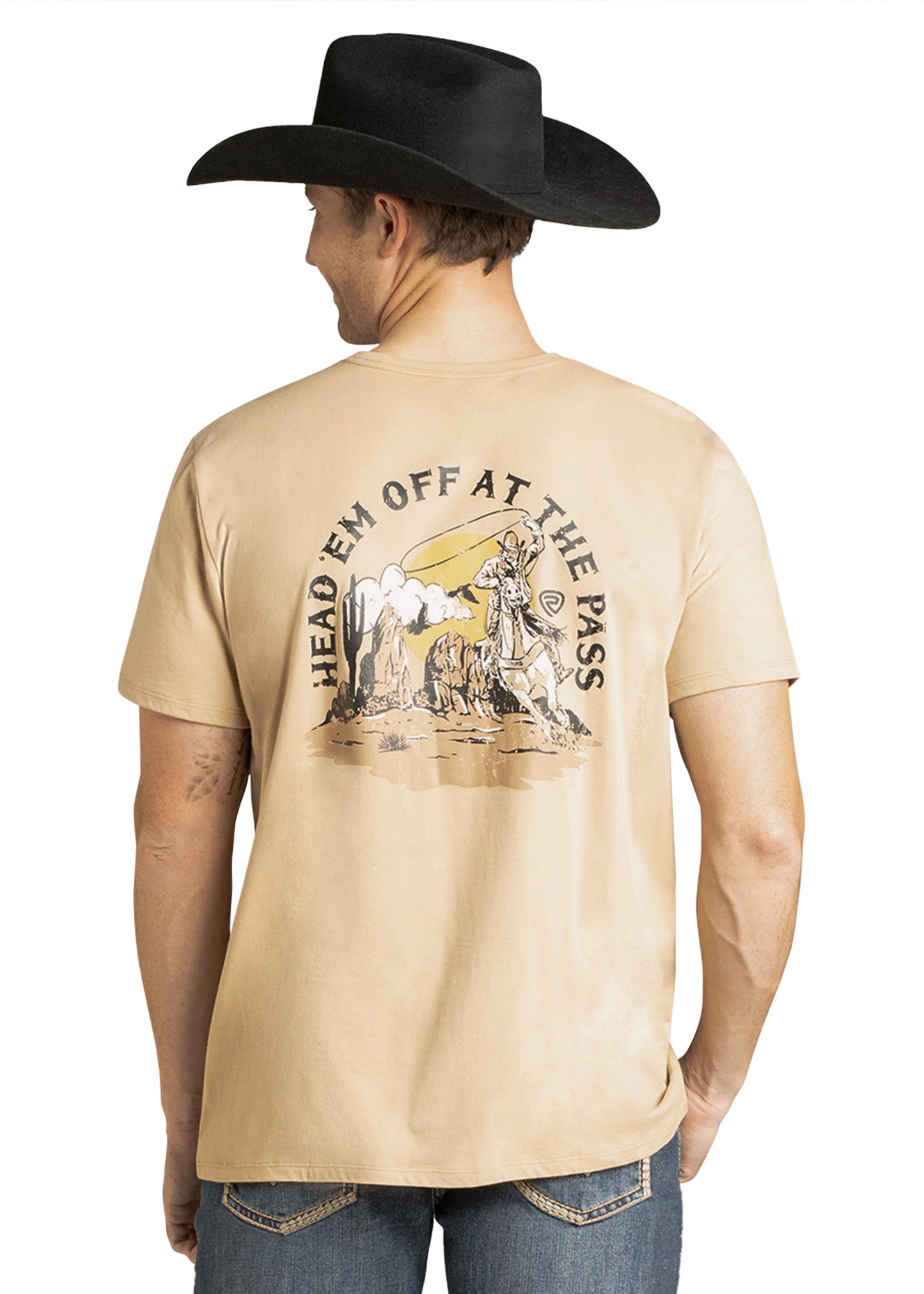 Man wearing a beige t-shirt with a graphic design and text, standing against a white background