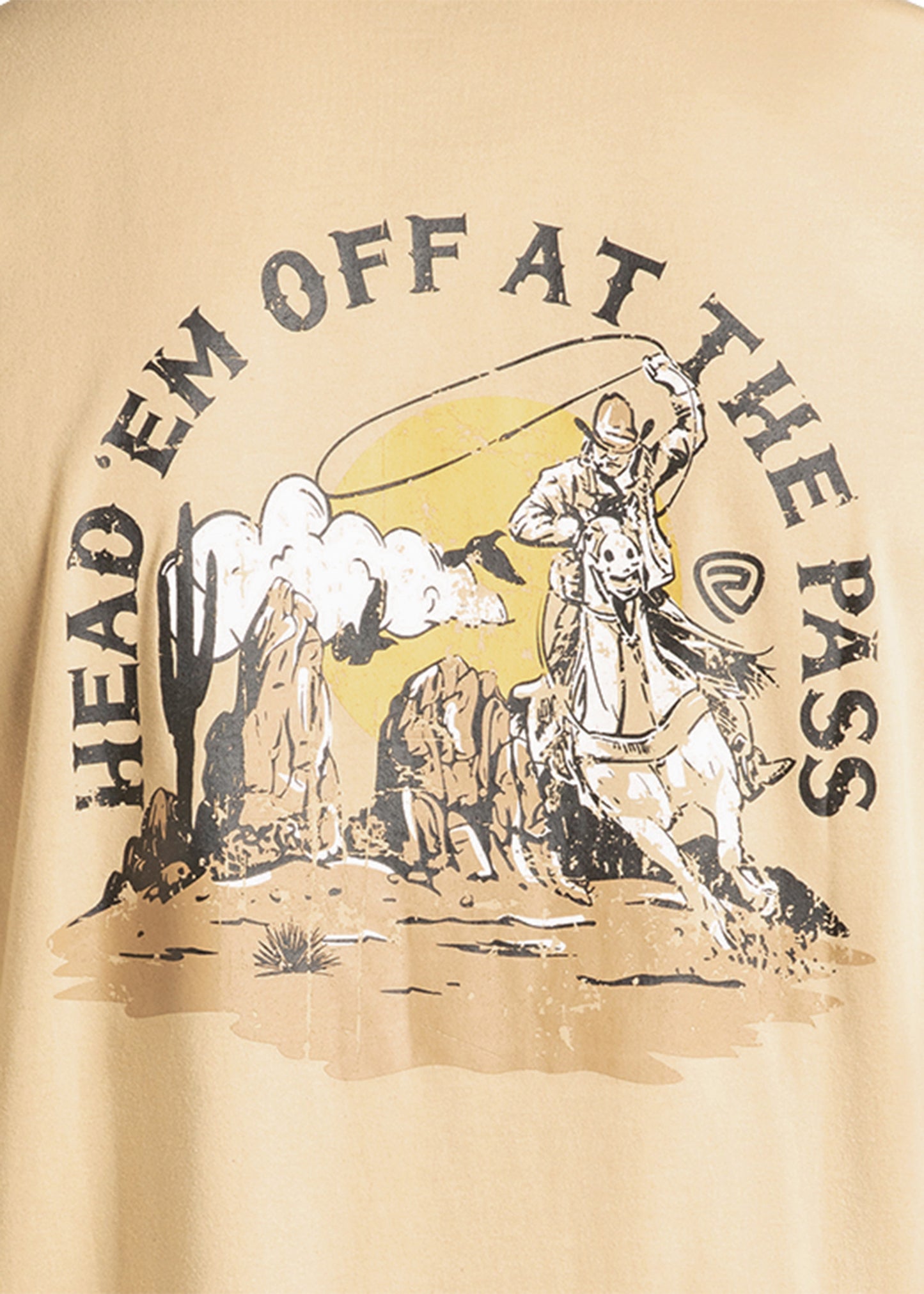 Beige t-shirt with a graphic of a cowboy and text 'HEAD 'EM OFF AT THE PASS' on a beige background.