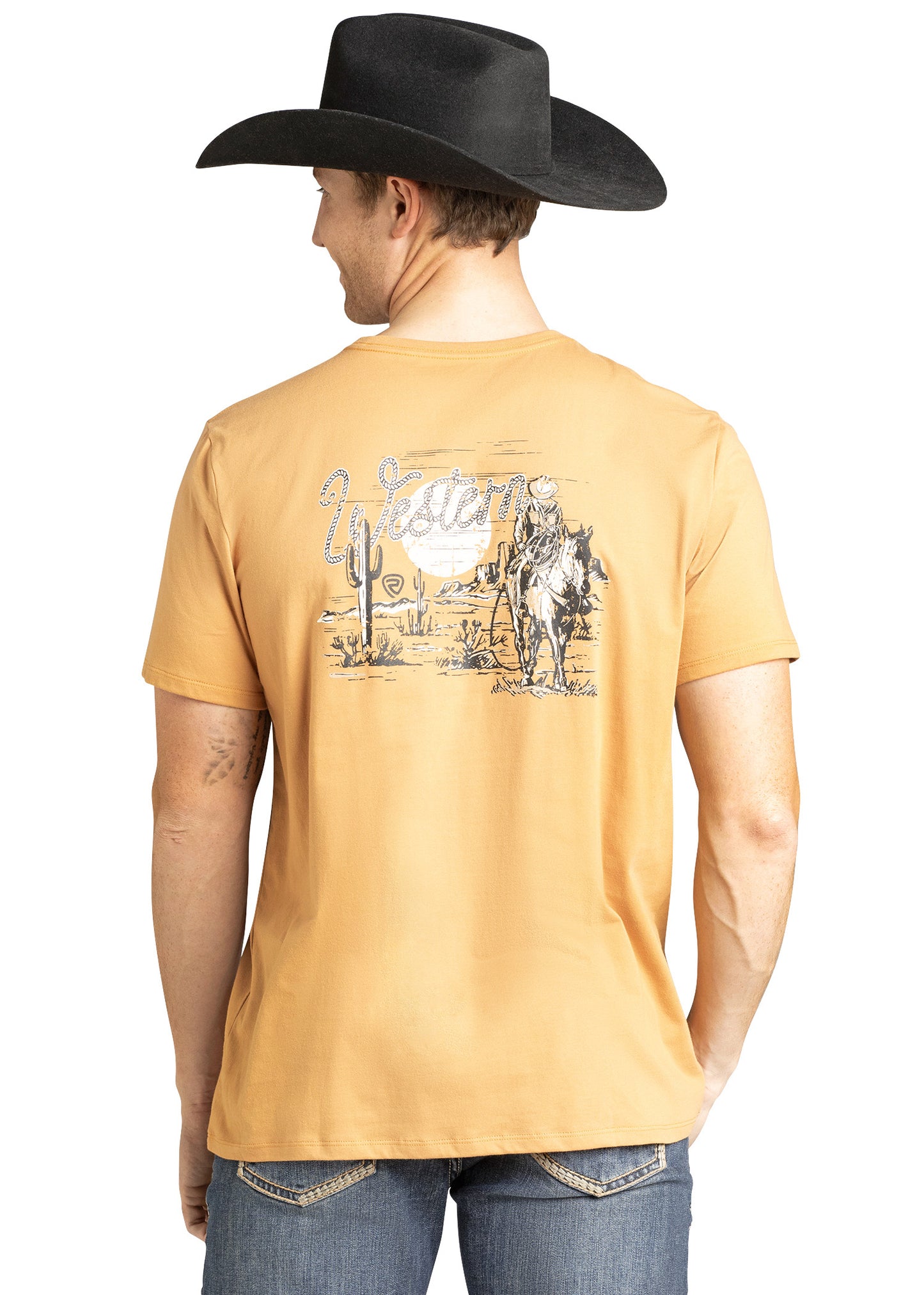Man wearing a mustard yellow t-shirt with a Western graphic and a black cowboy hat on a white background