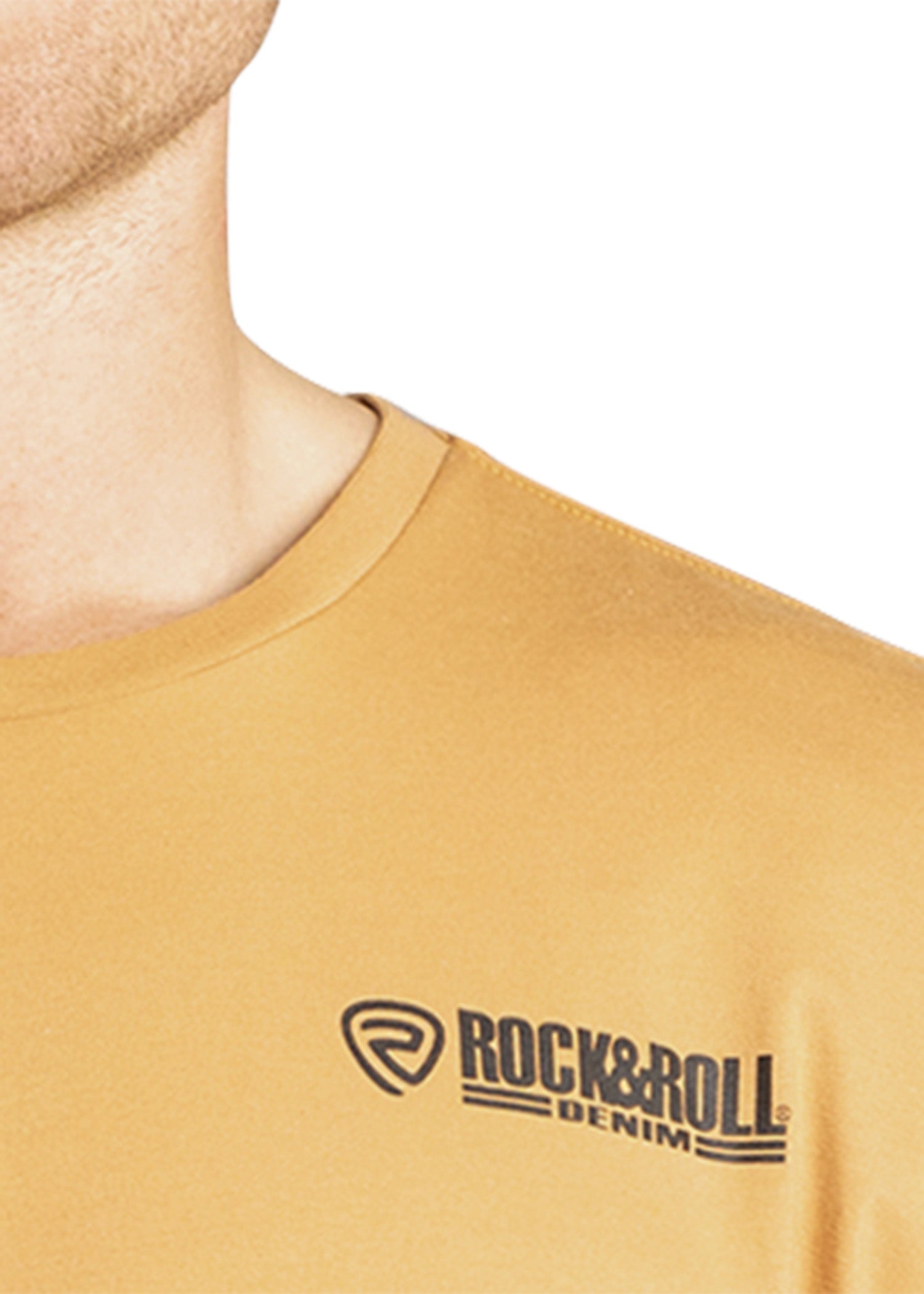 Close-up of a mustard yellow t-shirt with 'Rock & Roll Denim' logo on a white background