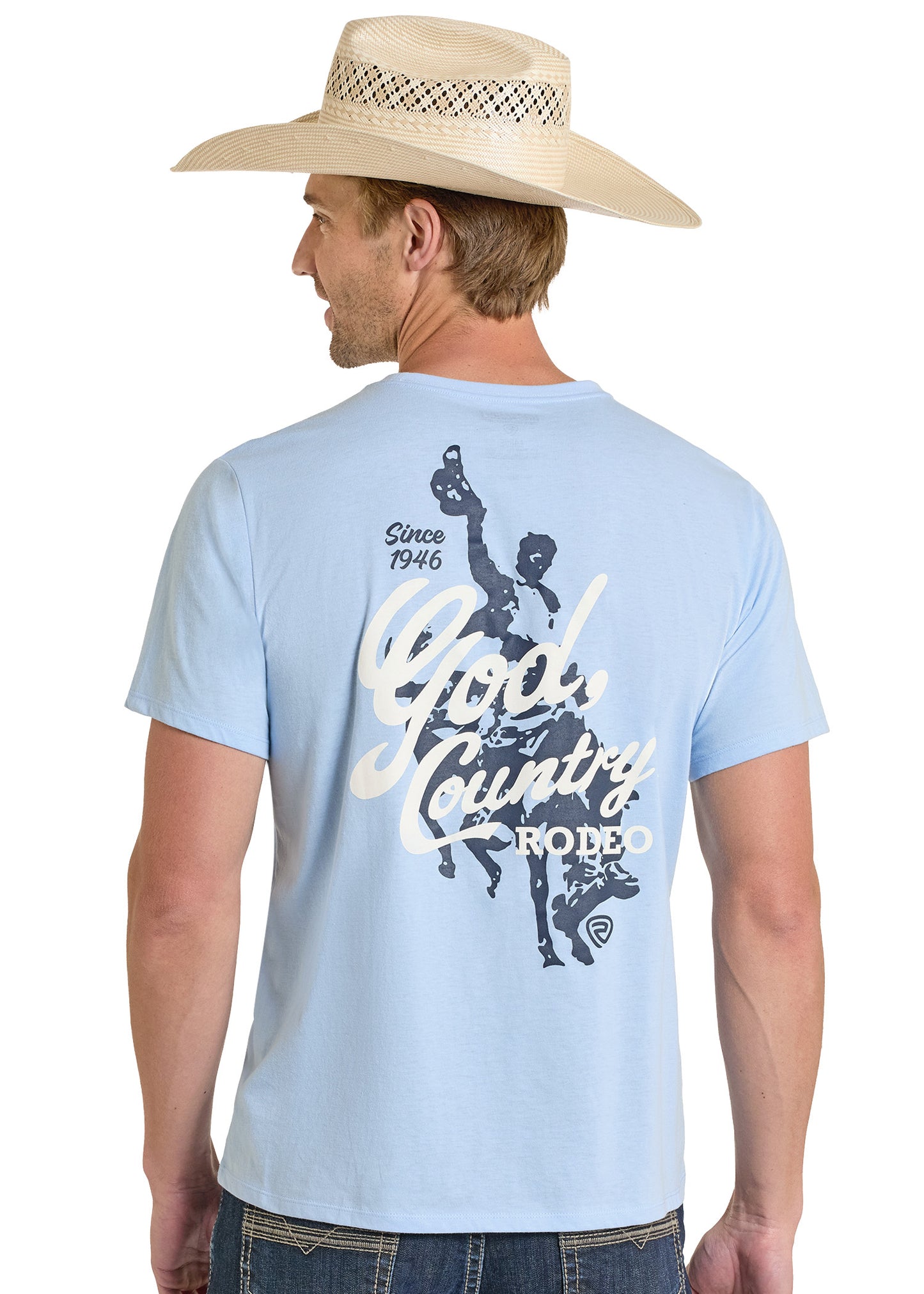 Man wearing a light blue t-shirt with a graphic design and text, standing against a white background.