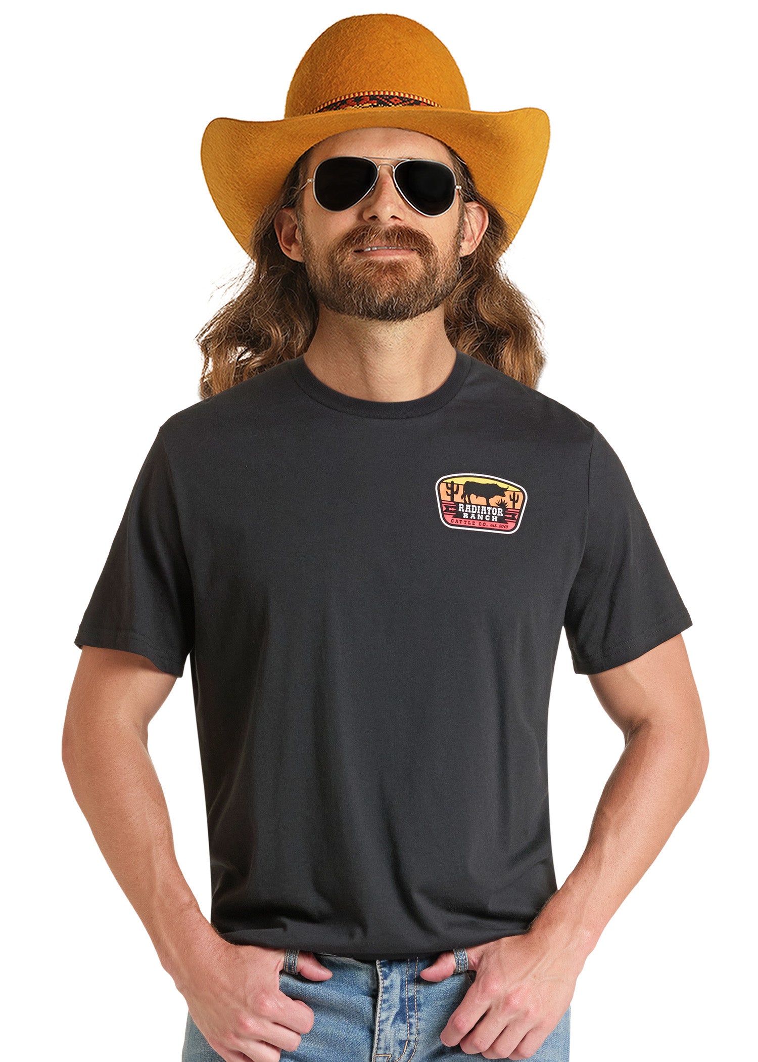 A man wearing a black crewneck t-shirt with a 'The Lone Ranger' chest graphic, styled with a yellow cowboy hat, sunglasses, and blue jeans against a white background.