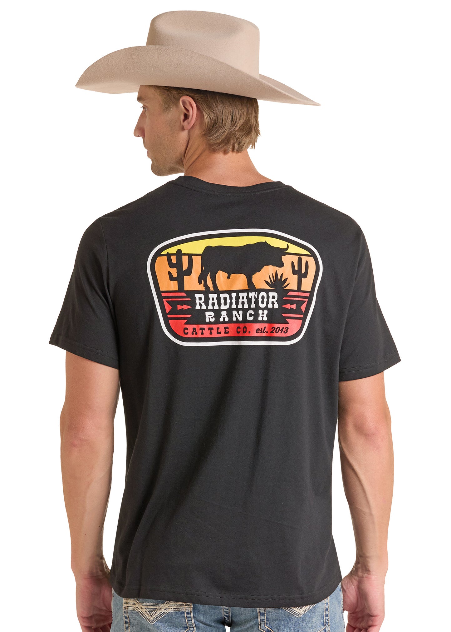 A man wearing a black short-sleeve t-shirt with a large 'Radiator Ranch Cattle Co' graphic on the back, paired with a beige cowboy hat and blue jeans, shown from a rear three-quarter view against a white background.