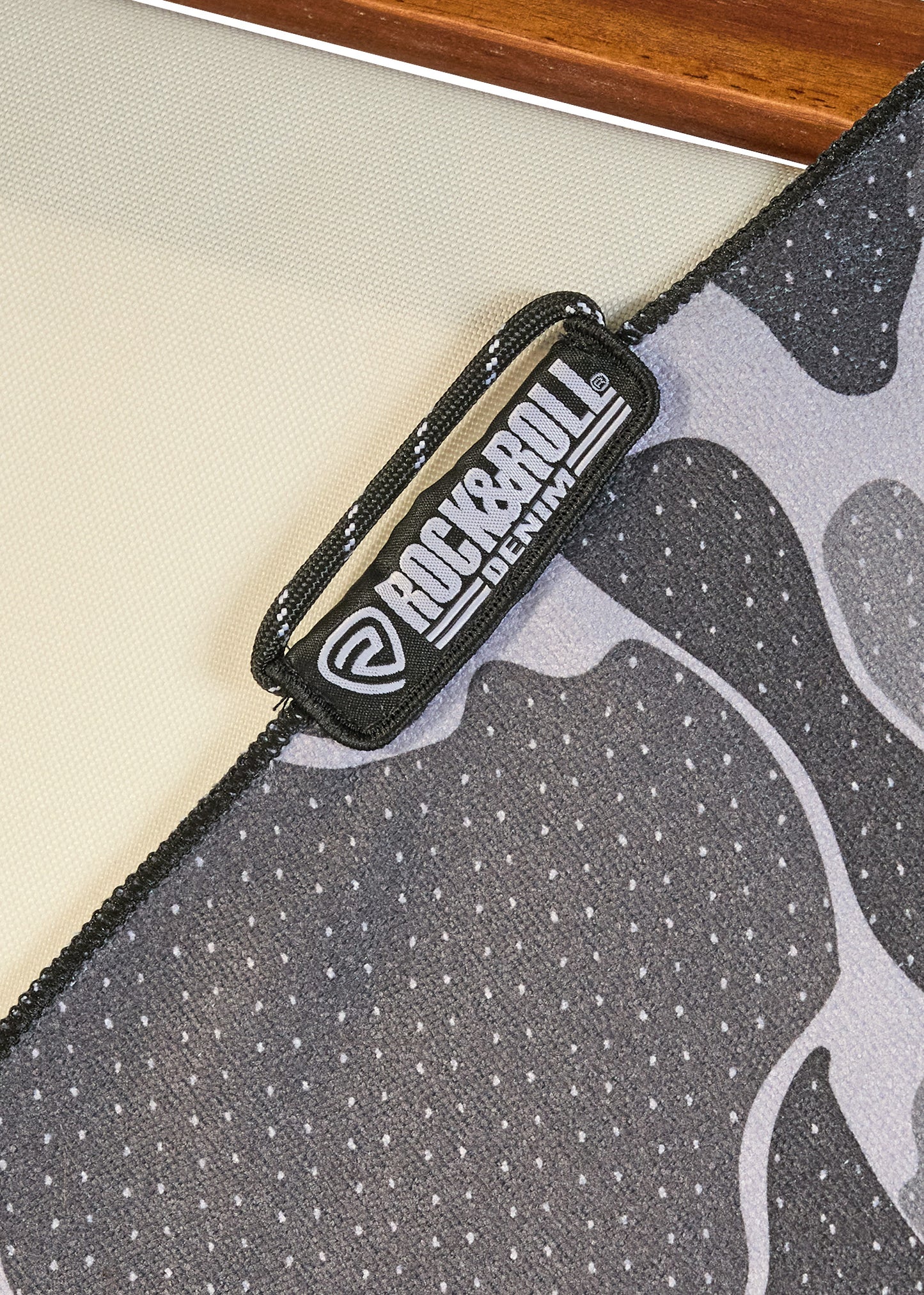 Close-up of a product with a 'Rock & Roll' logo on a textured surface
