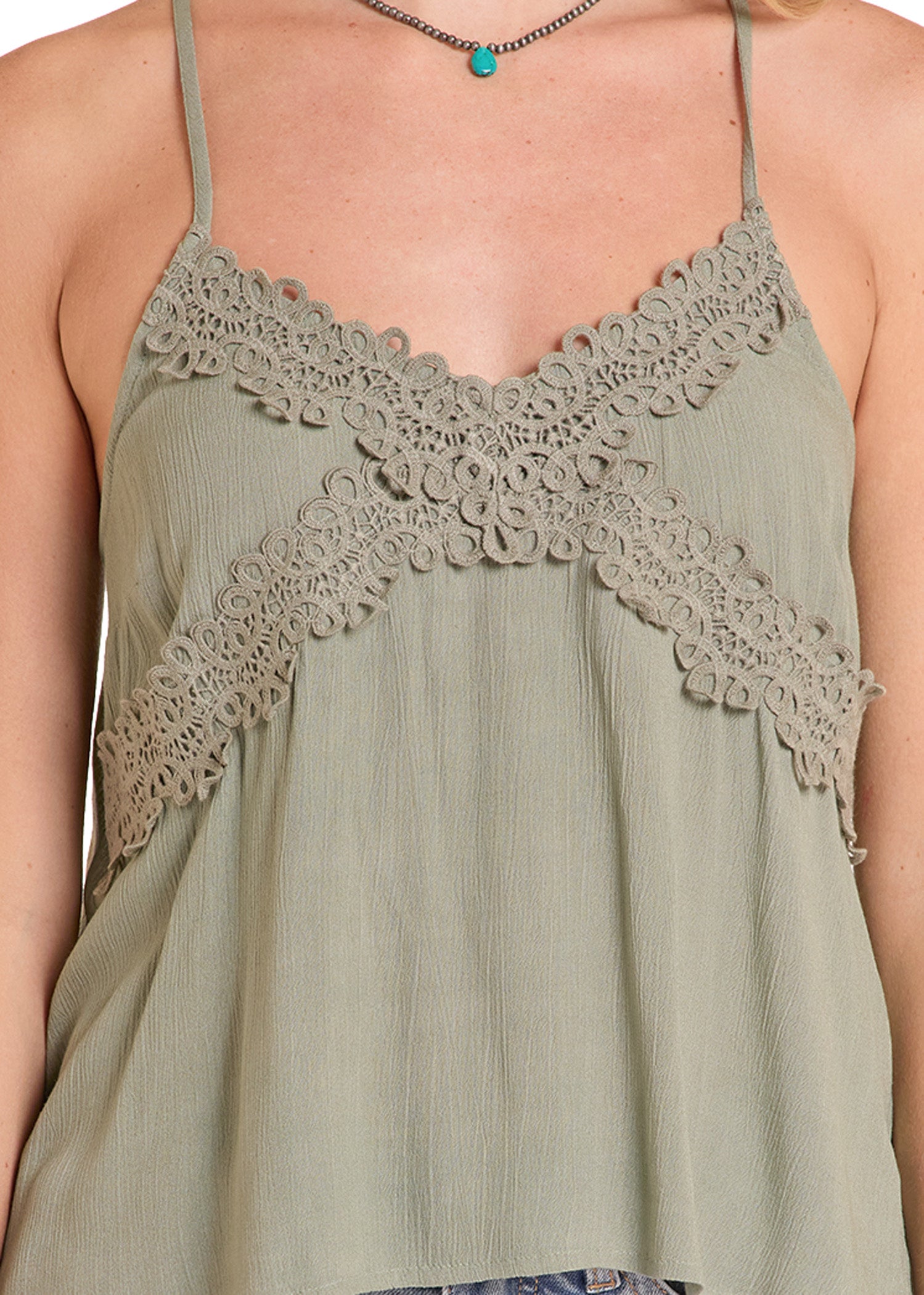 Green lace-trimmed top worn by a person