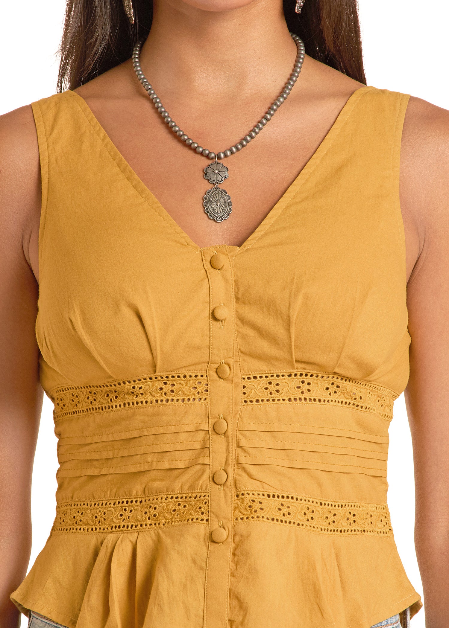 Yellow sleeveless top with lace details and a necklace on a white background