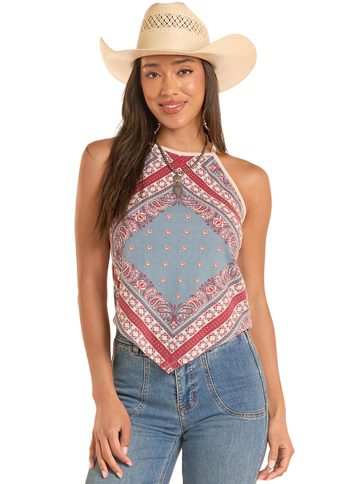 Woman wearing a patterned halter top and cowboy hat on a white background