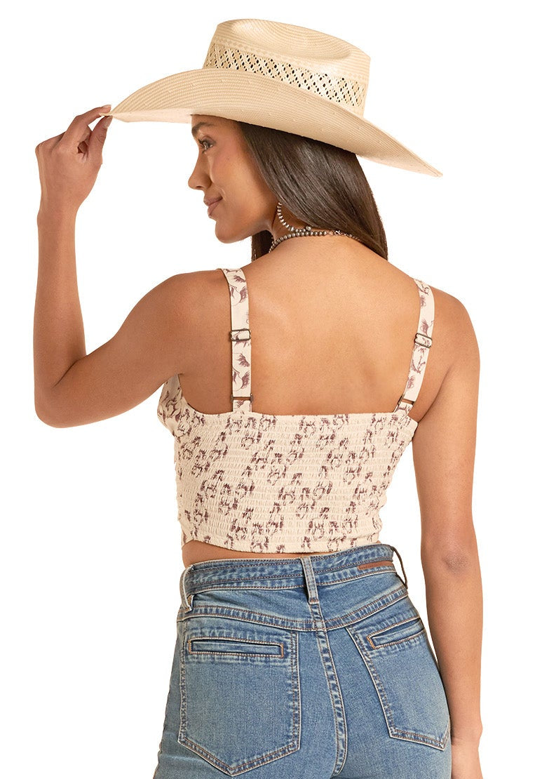 Woman wearing a horse top and blue jeans with a beige hat on a white background
