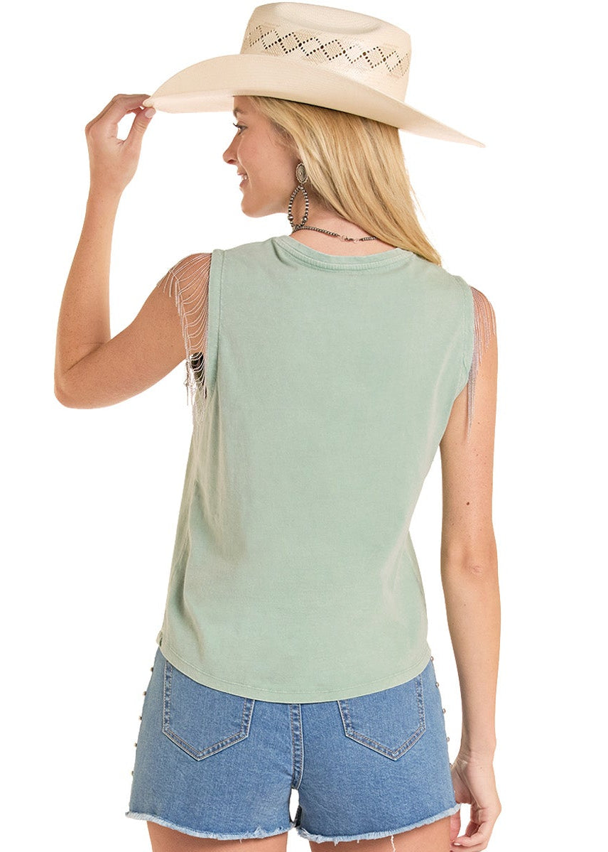 Woman wearing a sleeveless top, denim shorts, and cowboy boots on a white background