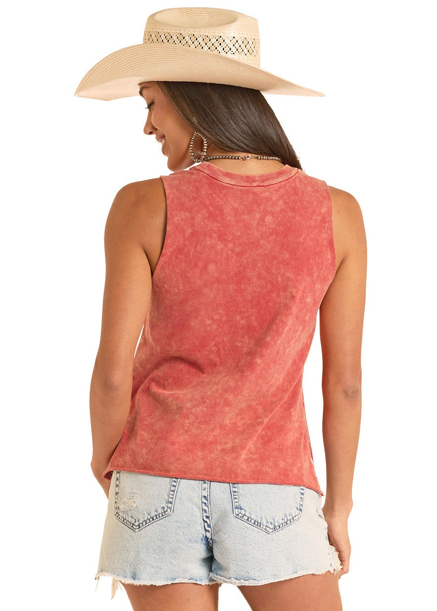 Woman wearing a red sleeveless top, denim shorts, and white cowboy boots on a white background