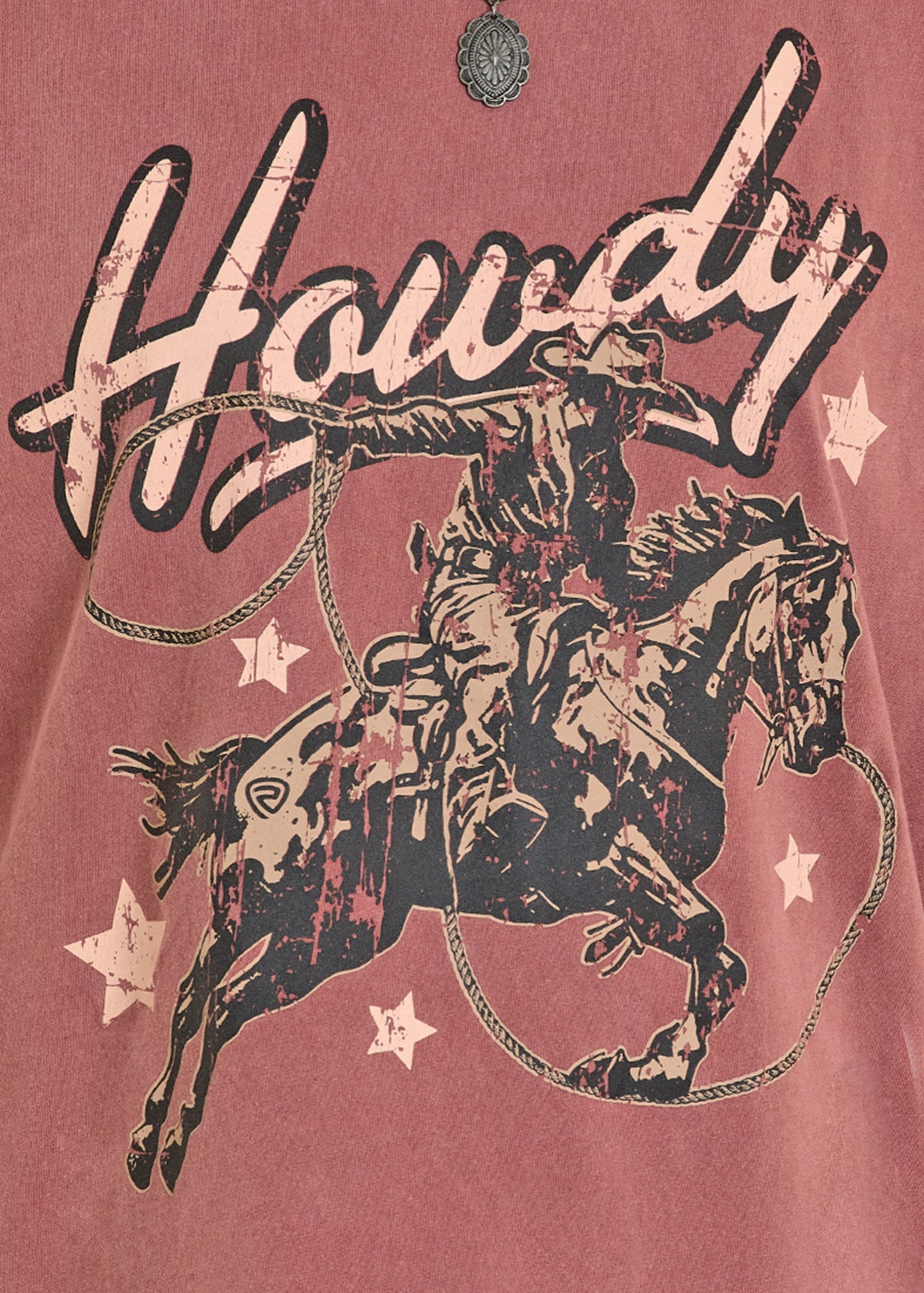 Vintage-style graphic of a cowboy on a horse with 'Howdy' text on a red background.