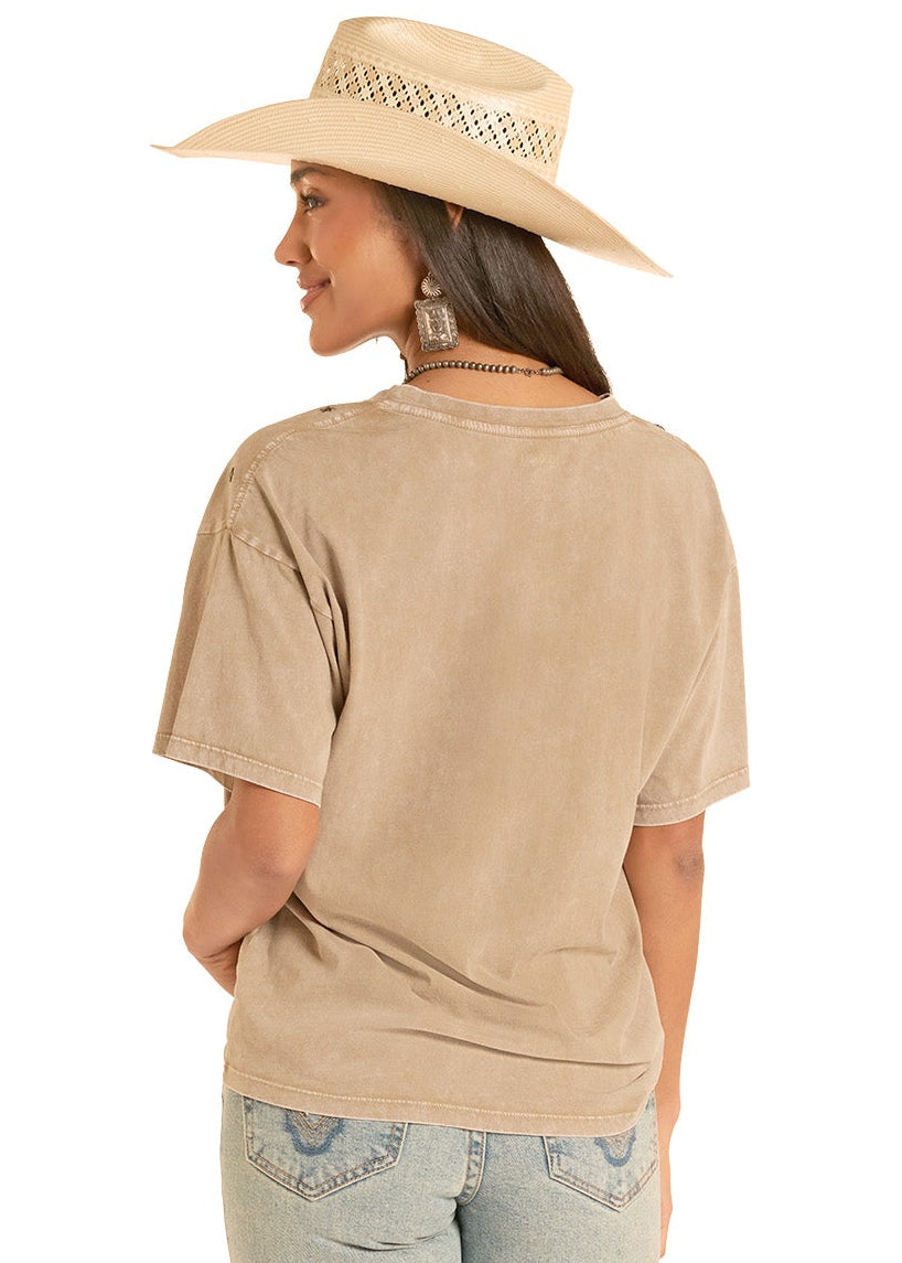 Woman wearing a beige shirt and light blue jeans with a white background