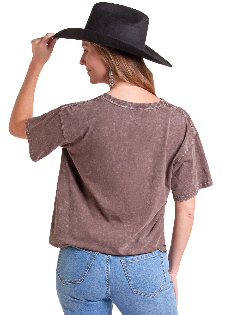 A woman shown from the back wearing a washed brown short-sleeve t-shirt, light blue jeans.