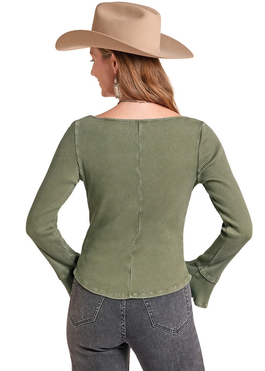 A woman shown from the back wearing an olive green long-sleeve top.