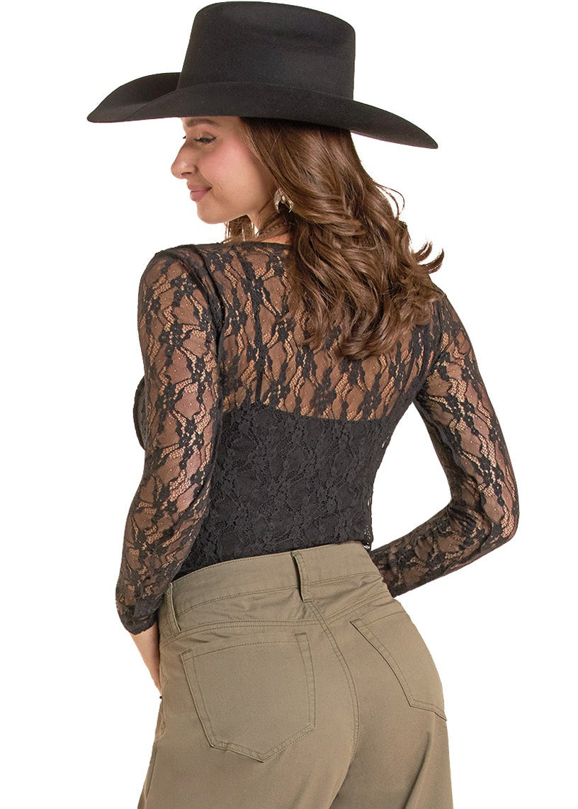 A woman shown from the back wearing a black wide-brim cowboy hat, a black lace long-sleeve top, olive green wide-leg pants, and black ankle boots, against a plain white background.