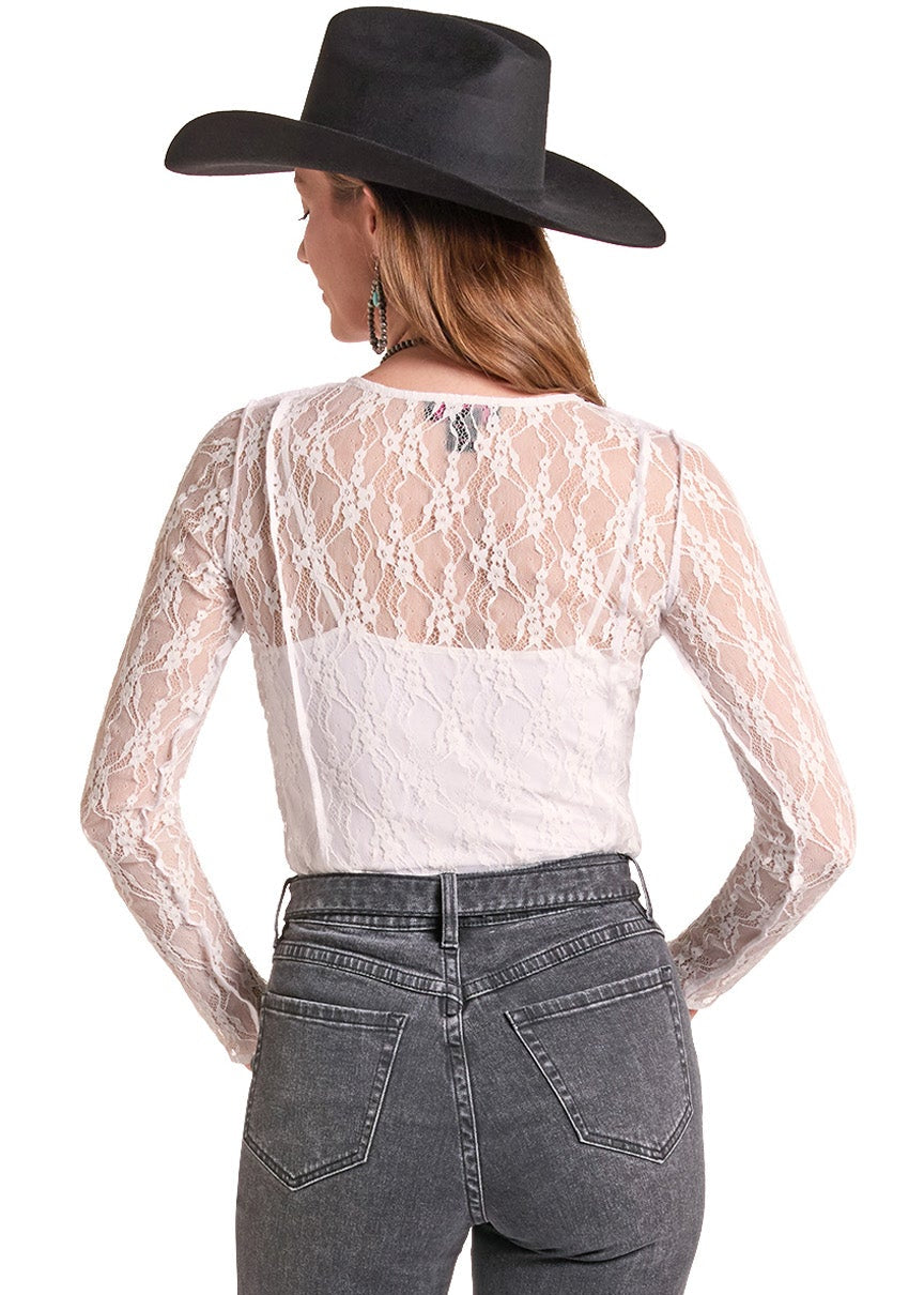 A woman shown from the back wearing a black cowboy hat, a white lace long-sleeve top, and gray high-waisted flare jeans against a plain white background.