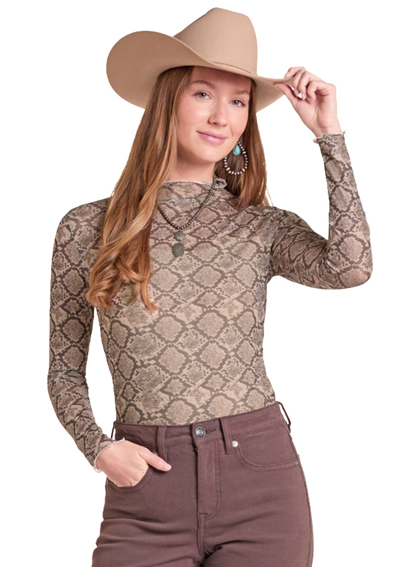 A woman modeling a fitted long-sleeve top with a snakeskin pattern in beige and brown, paired with brown pants and a tan cowboy hat.