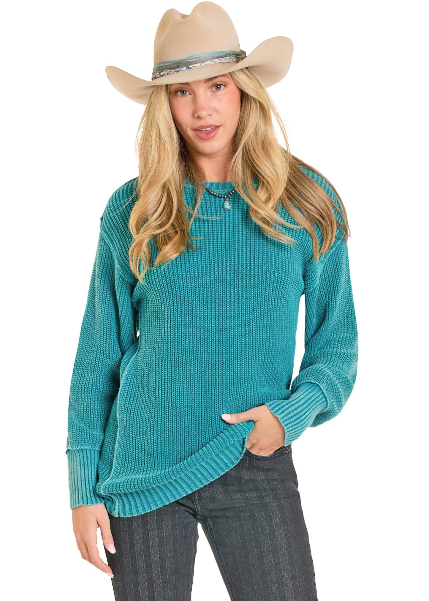 Woman wearing a teal sweater and beige cowboy hat on a white background