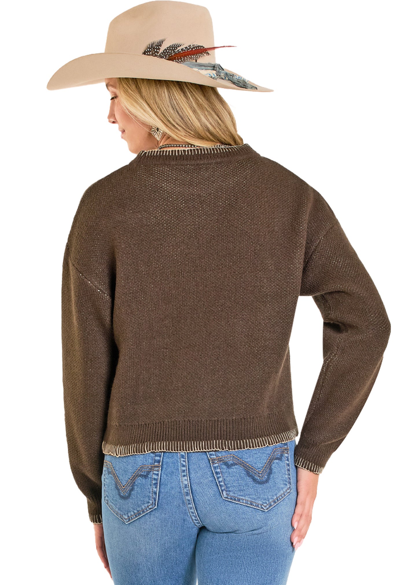 Woman in a white cowboy hat and brown sweater