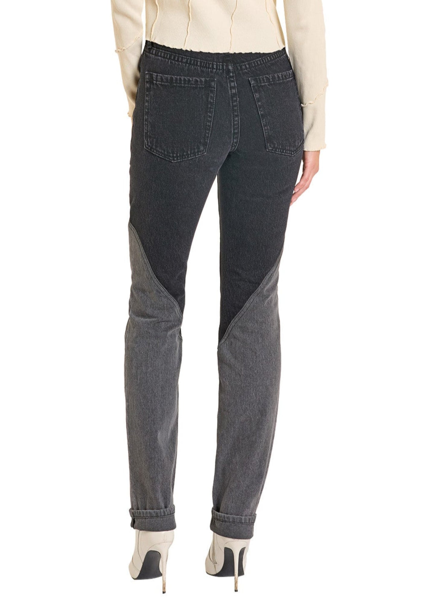 Person wearing dark gray jeans on a white background