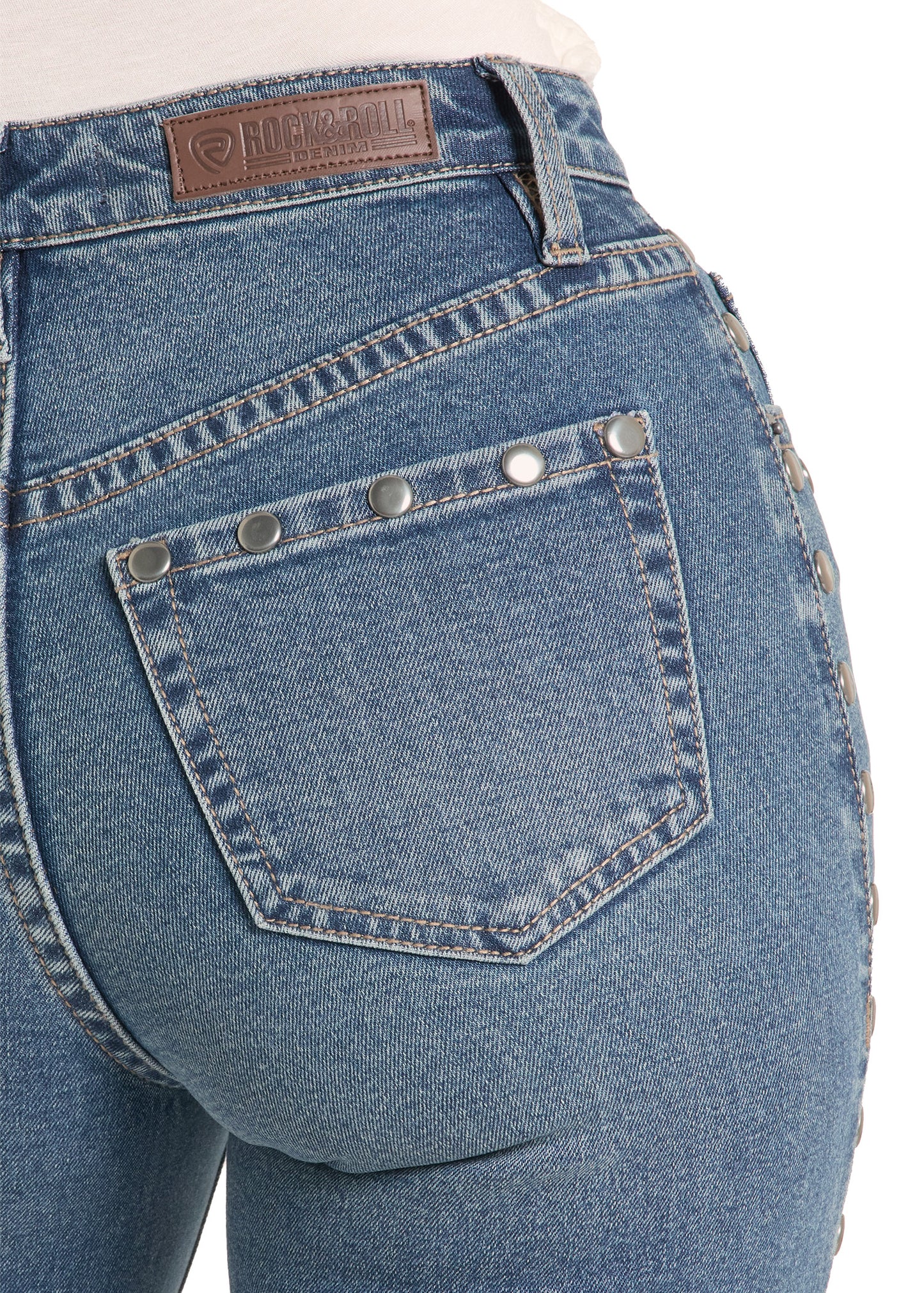 Close-up of blue jeans with a brand label on a white background