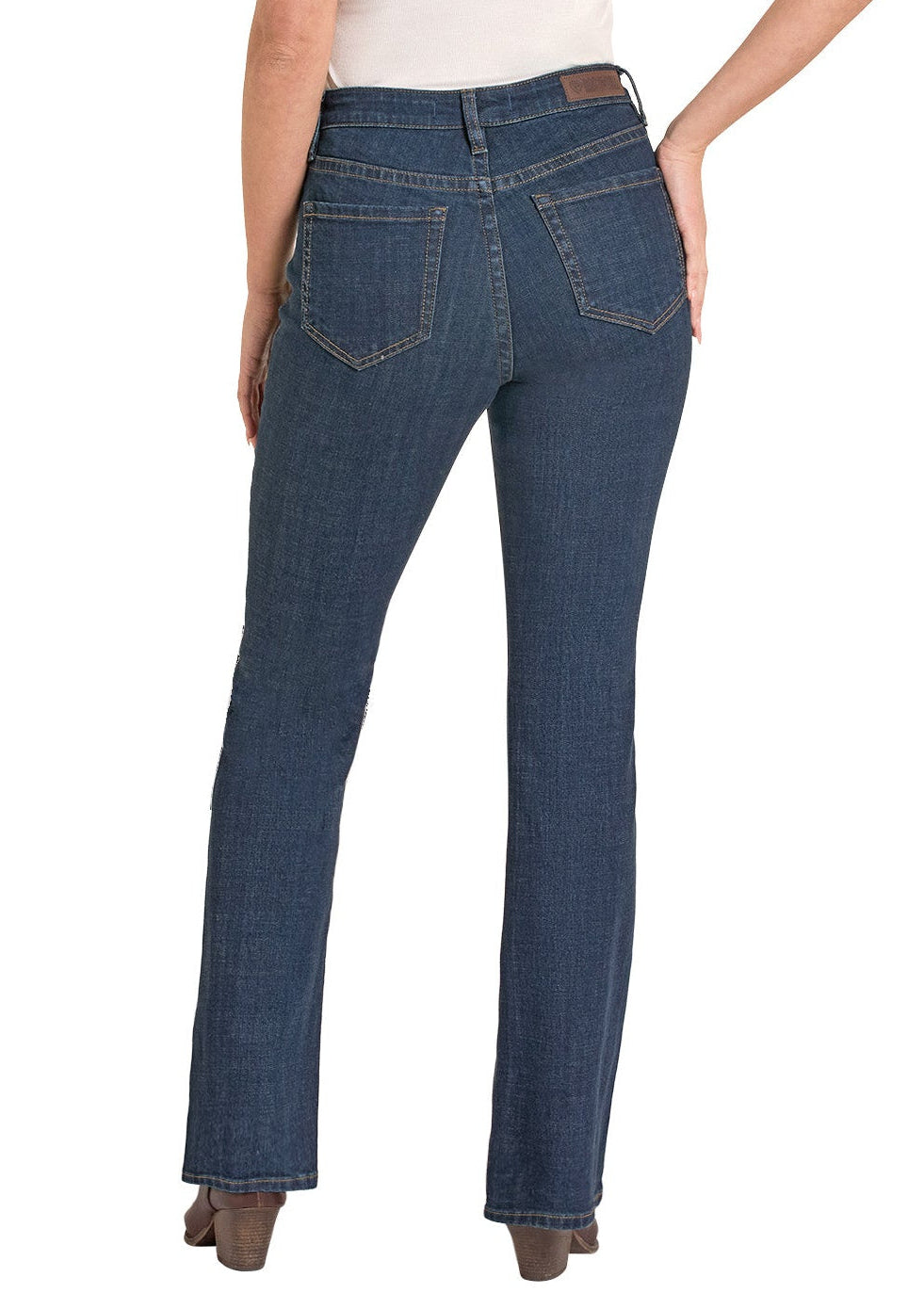 Woman wearing blue jeans and a beige hat on a white background