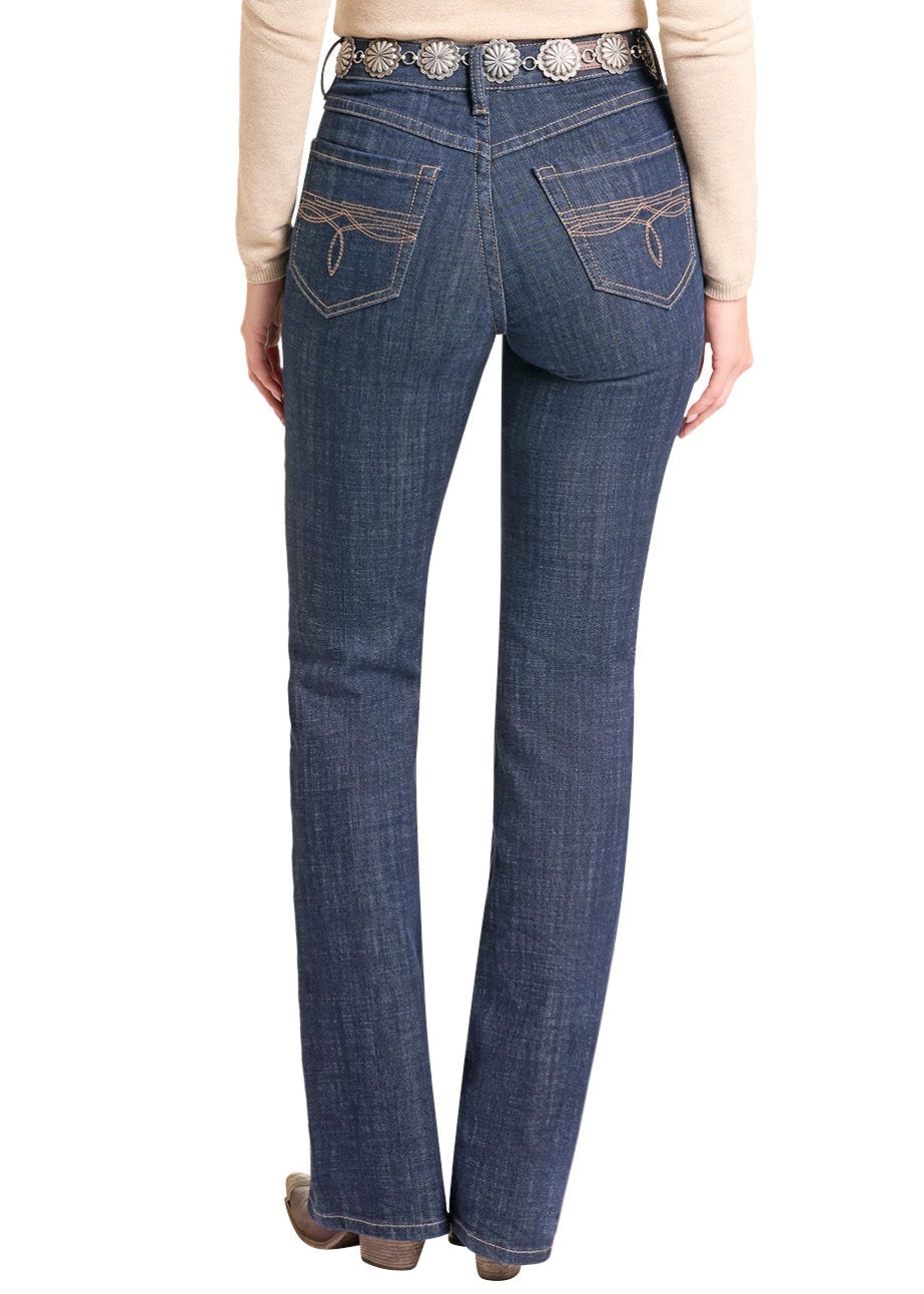 A woman shown from the back wearing a black cowboy hat, a beige long-sleeve top, and dark blue jeans with a decorative silver-toned belt, against a plain white background.