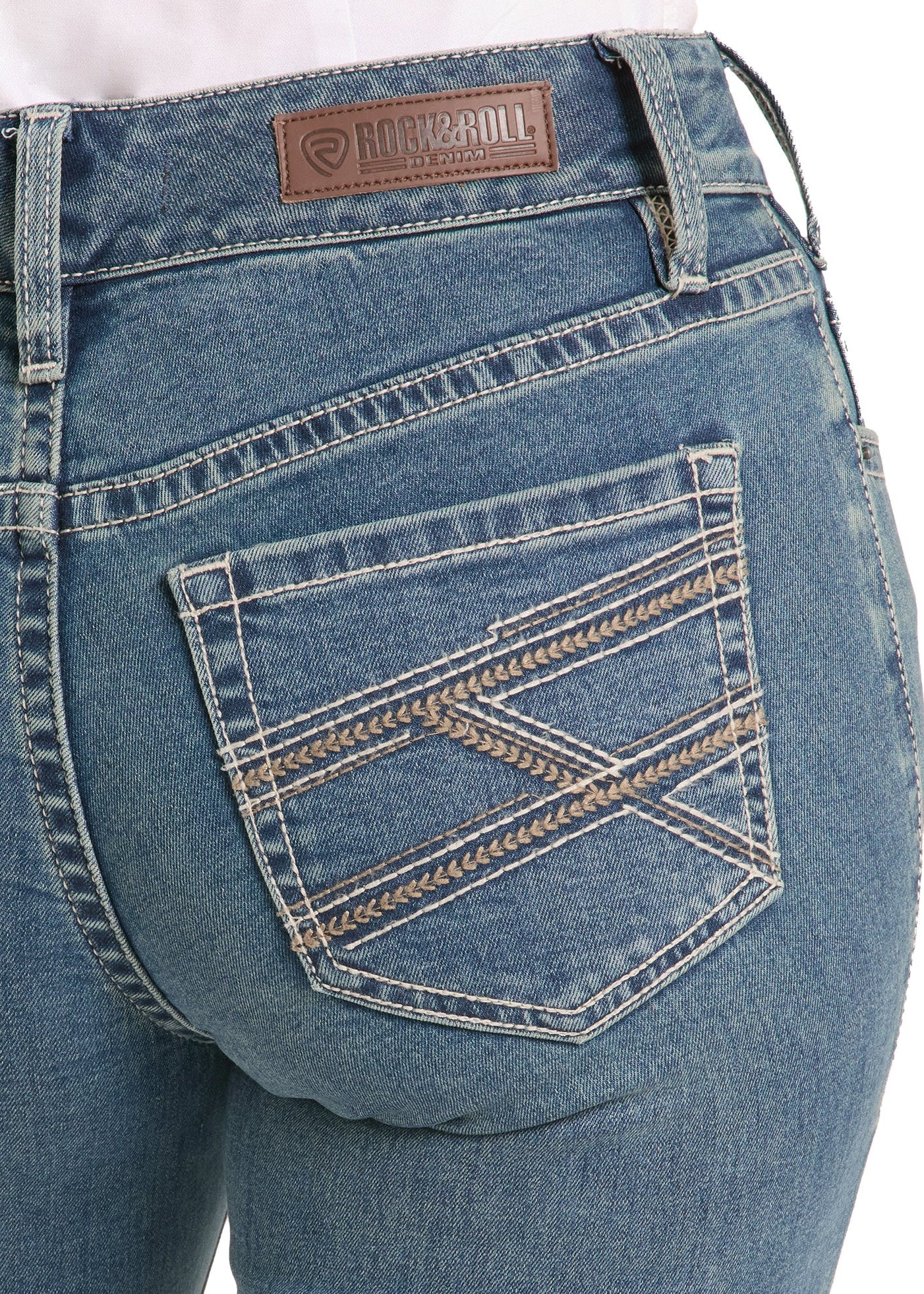 Close-up of blue jeans with a brand label on a white background