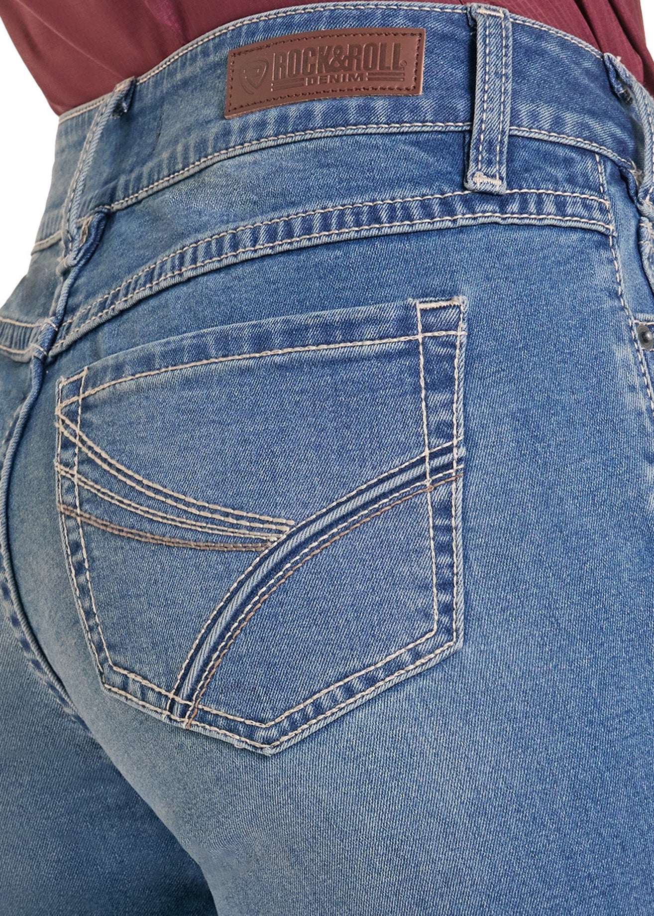 Close-up of the back waistband and rear pocket of blue denim jeans, showing a brown leather patch with the brand name 'Four by Roll'.